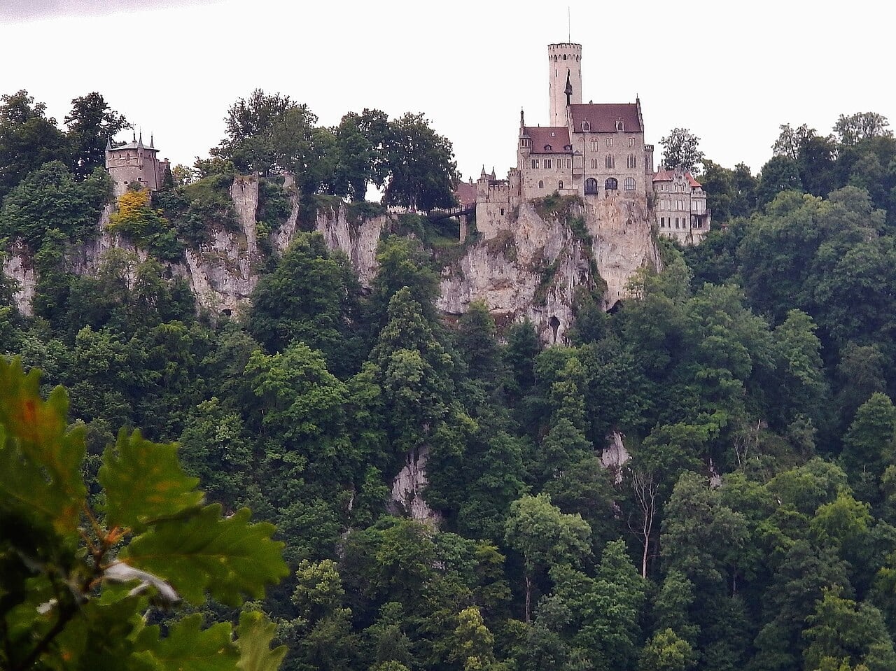 The 19th-Century Romantic Revival of German Castles 7 Schloss Lichtenstein on its limestone needle above the Echaz valley, with the medieval ruin of Alt-Lichtenstein visible nearby on a separate outcrop.