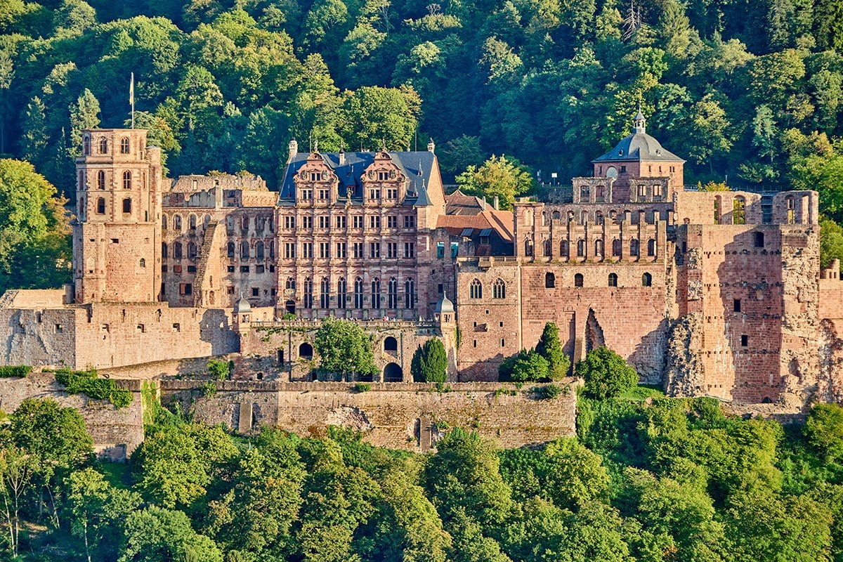 Heidelberg Castle 1 Heidelberg Castle in summer from the Philosophenweg, red sandstone ruins framed by forest on the Königstuhl