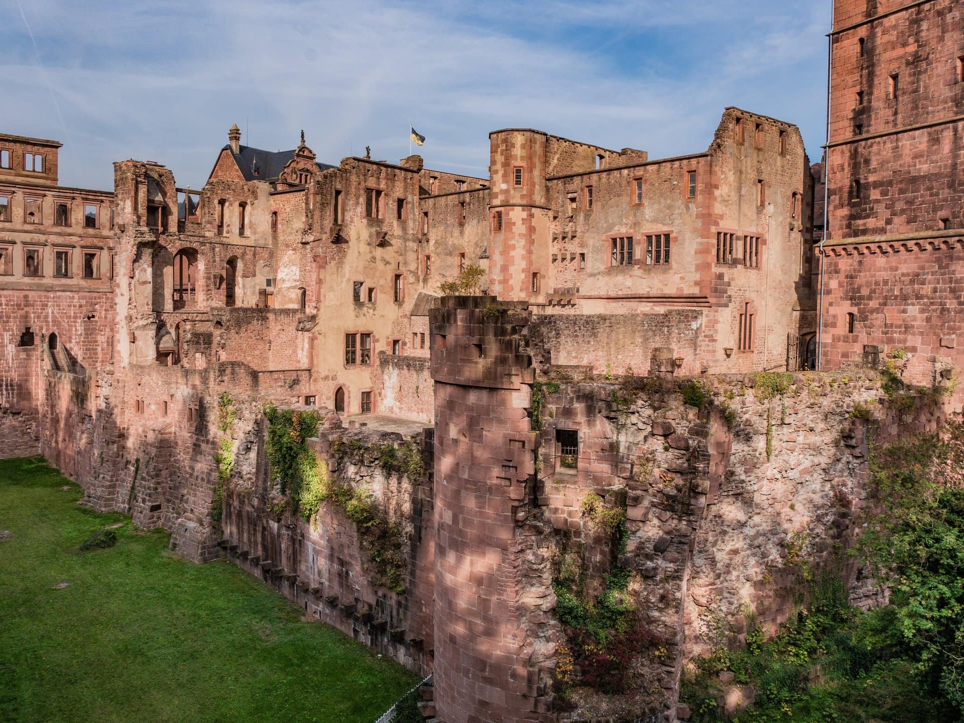 Heidelberg Castle 6 Ruined palace wings and moat of Heidelberg Castle, broken walls and empty windows rising above a grassy ditch