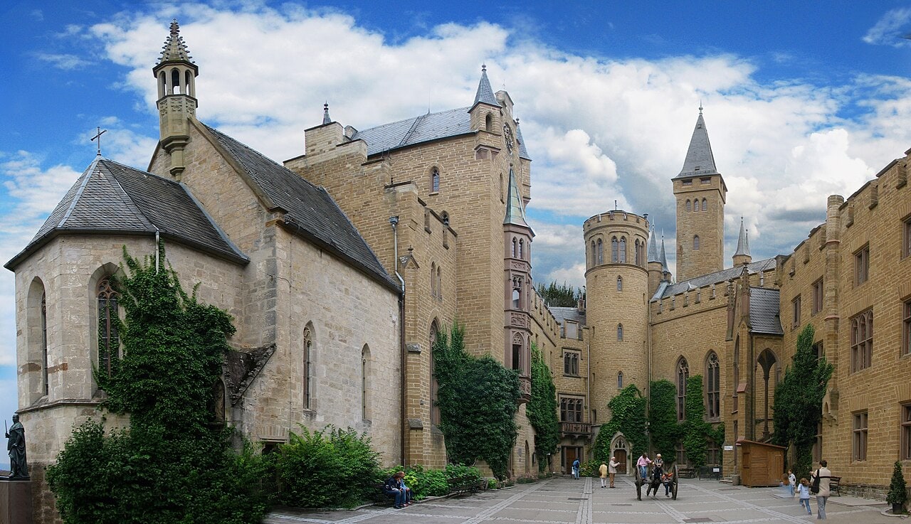 Hohenzollern Castle 4 Inner courtyard of Hohenzollern Castle showing the pale 15th-century St. Michael's Chapel on the left and the 19th-century Neo-Gothic sandstone castle buildings behind