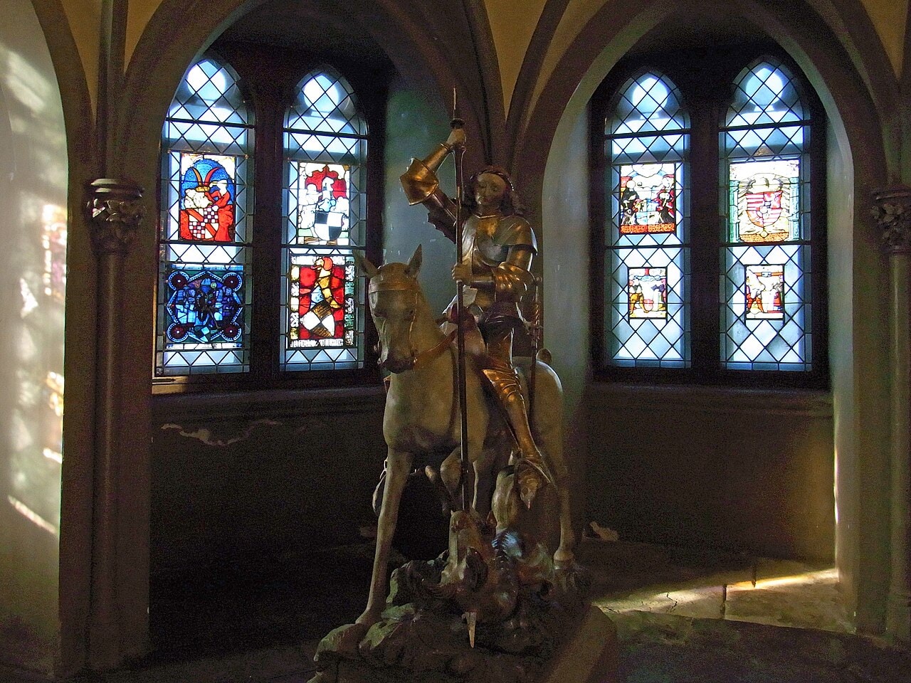 Hohenzollern Castle 6 Vestibule of the St. Michael's Chapel at Hohenzollern Castle showing the equestrian statue of St. George and 15th-century heraldic stained glass windows in Gothic arched frames