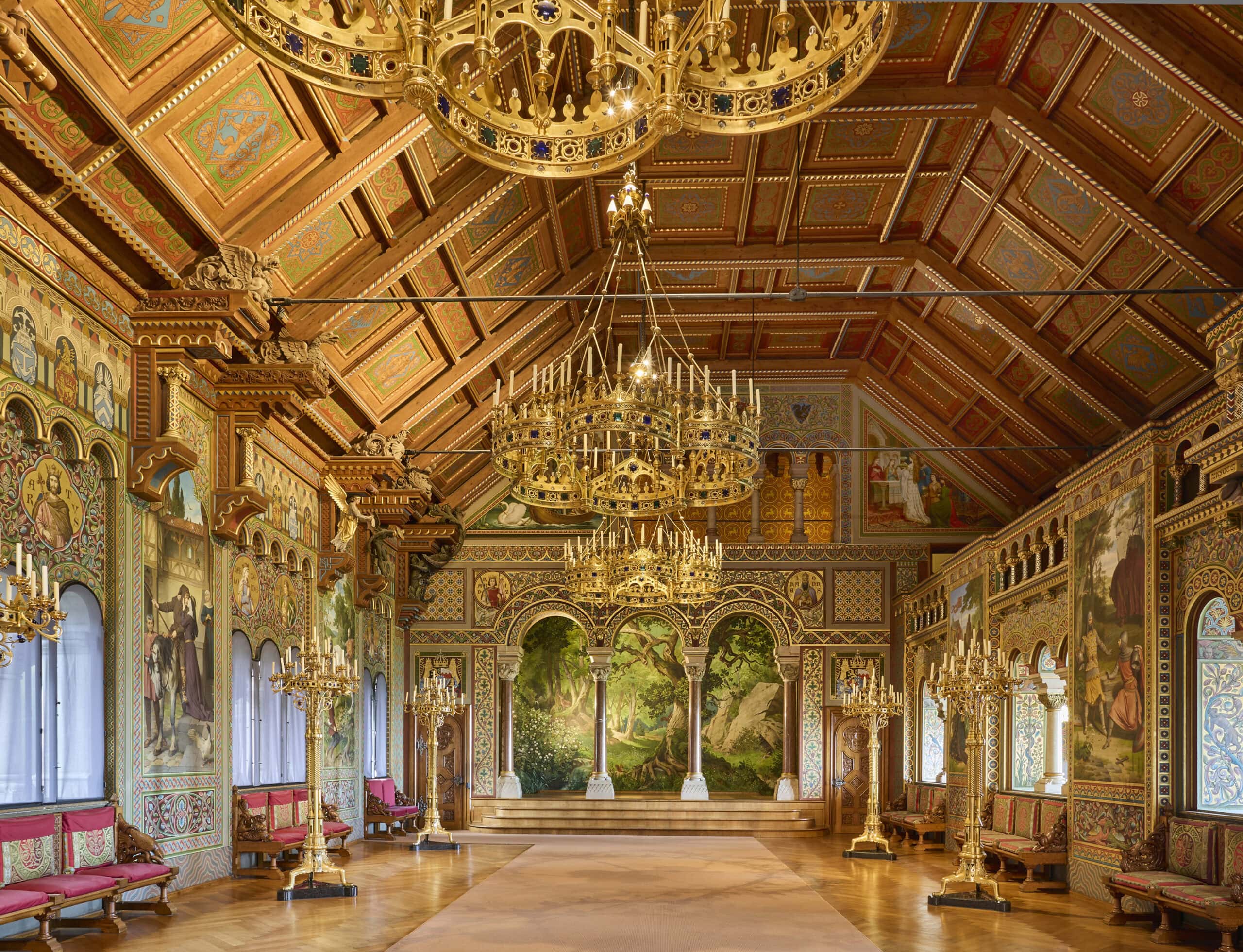 Neuschwanstein Castle 5 Interior of the Singers' Hall at Neuschwanstein Castle showing gilded arches, Wagnerian murals, chandeliers, and the raised Singers' Bower at the western end