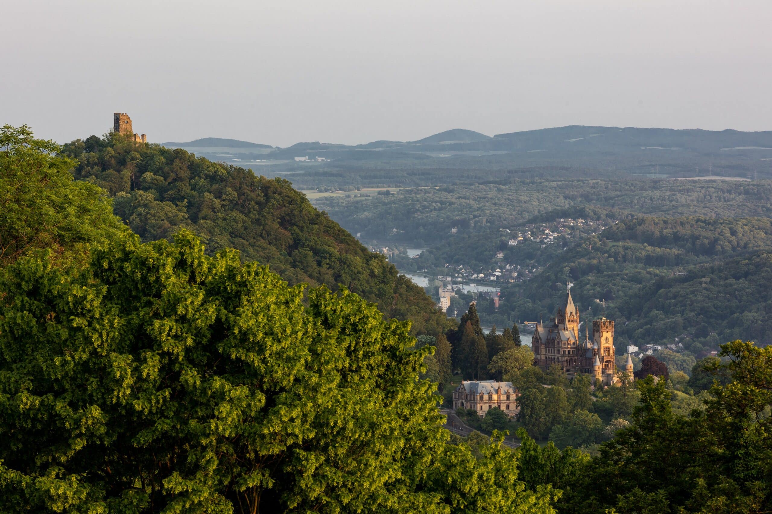 Drachenburg Castle 2 Distant view from the Petersberg showing the medieval ruin of Burg Drachenfels at top left and Schloss Drachenburg at lower right on the same Rhine slope