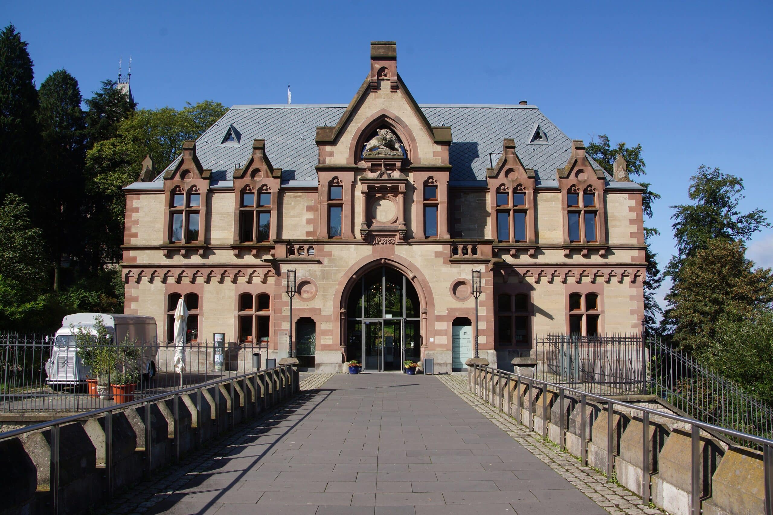 Drachenburg Castle 7 Front view of the Vorburg gatehouse at Schloss Drachenburg showing the symmetrical sandstone facade with central arched entrance