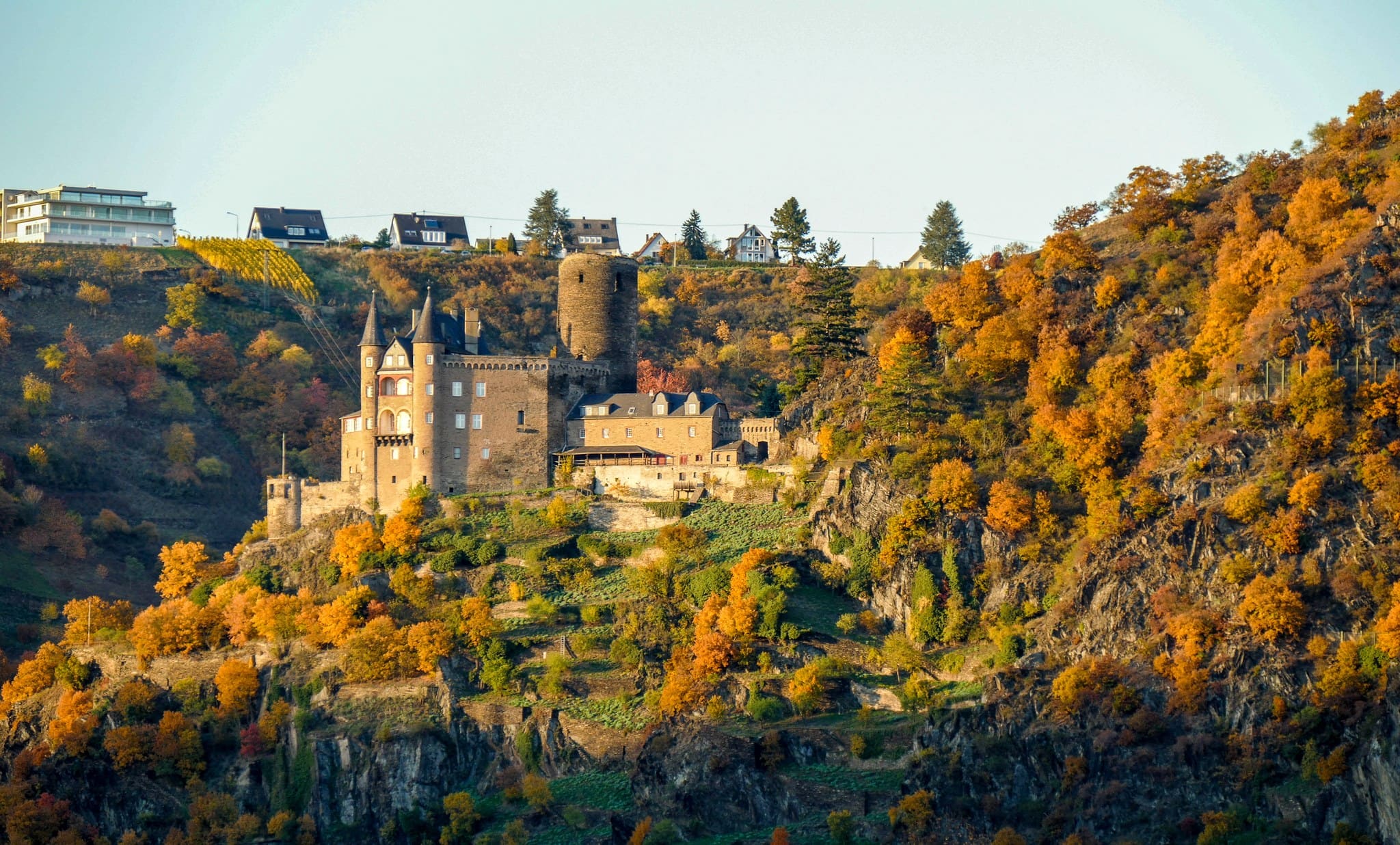 Katz Castle 3 The ruined round medieval keep of Katz Castle, about thirty metres tall, beside the historicist towers, with the Rhine below