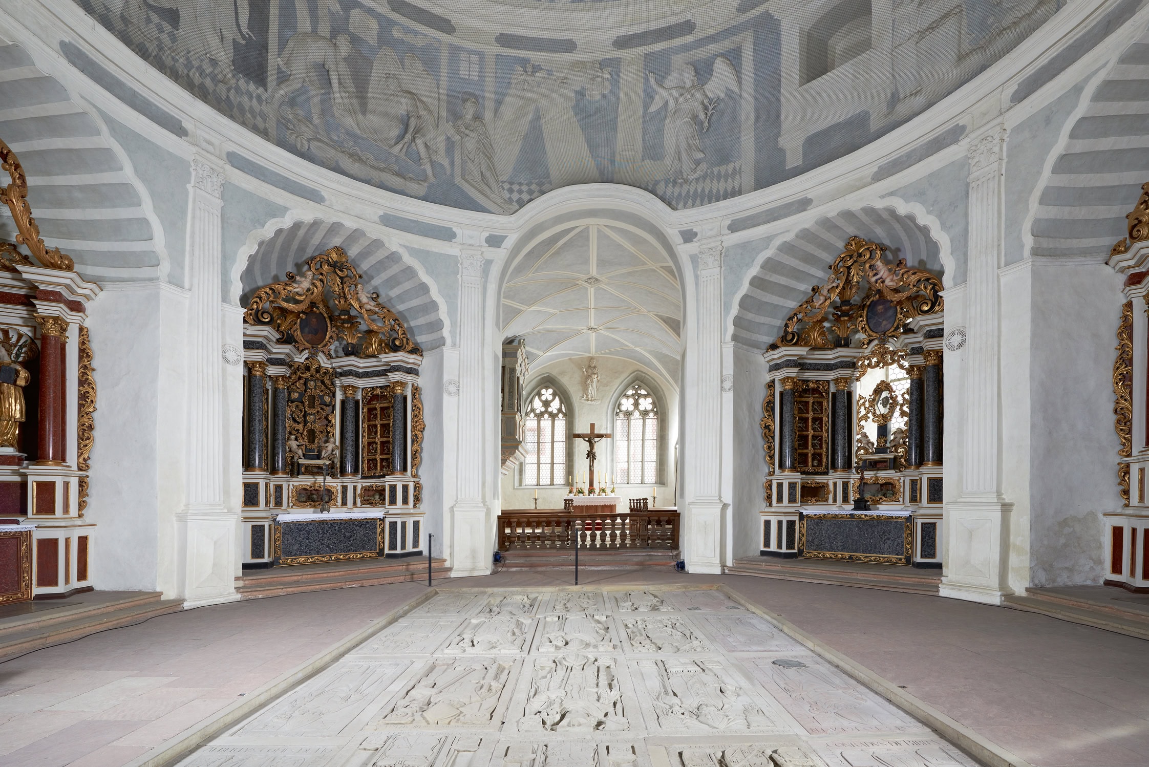Marienberg Fortress 7 Interior of the Marienkirche at Marienberg Fortress, with round nave, baroque side altars, fresco cupola, and bishops' tomb-slabs in the floor