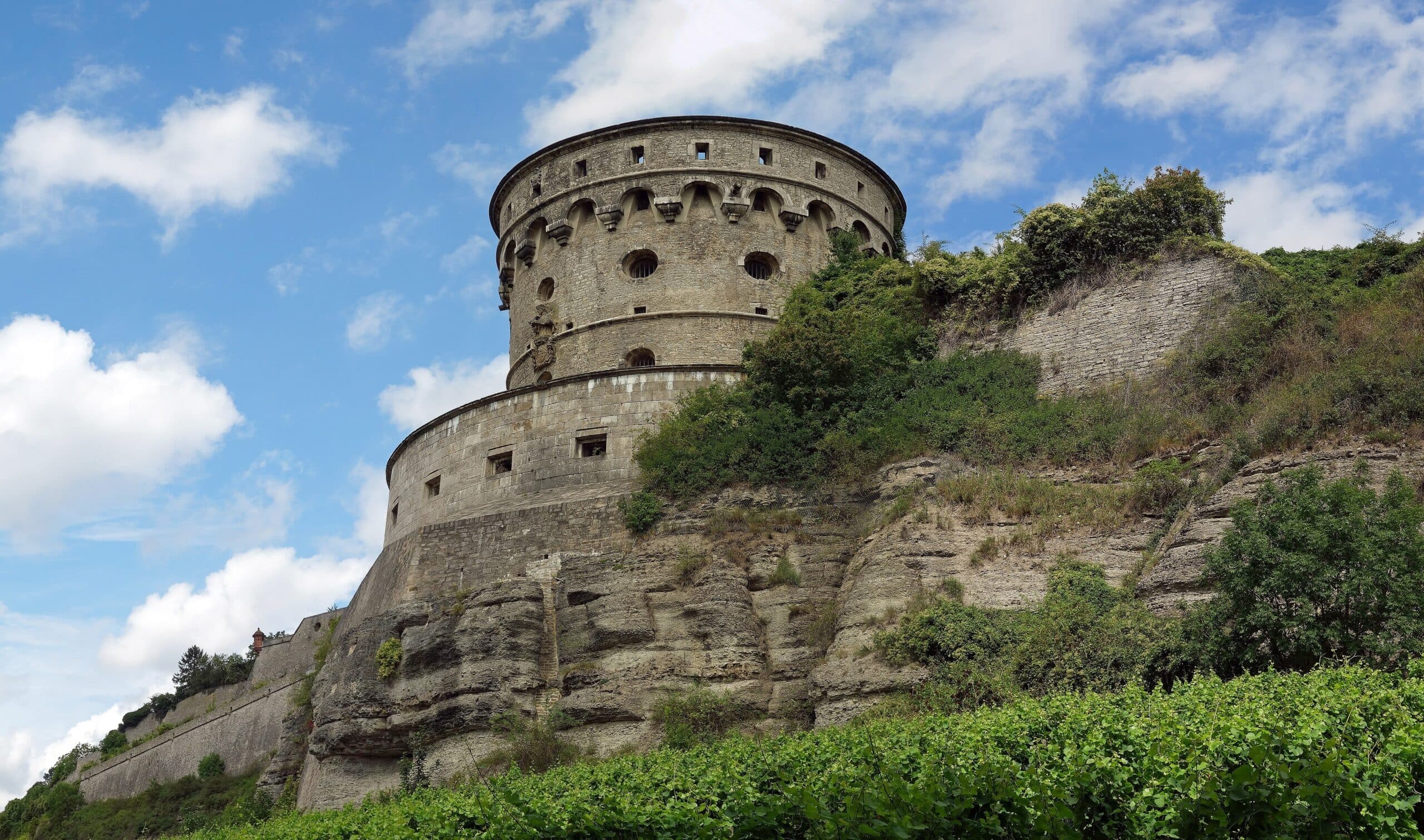 Marienberg Fortress 6 The Maschikuliturm, a round Baroque artillery tower with corbelled gallery and embrasures, on the southwest cliff edge of Marienberg Fortress