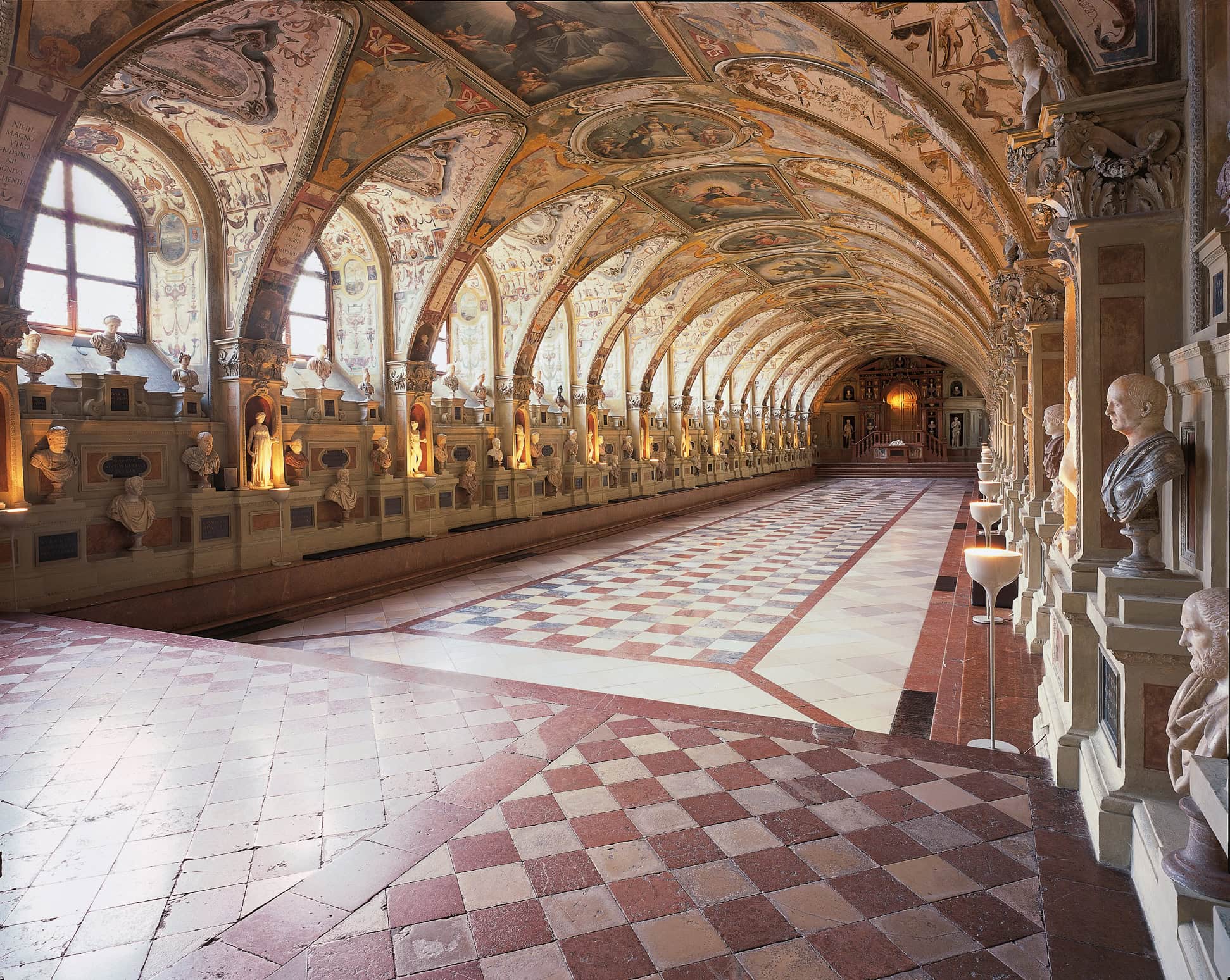 Long barrel-vaulted Antiquarium hall in Munich Residenz lined with antique busts and grotesque ceiling frescoes
