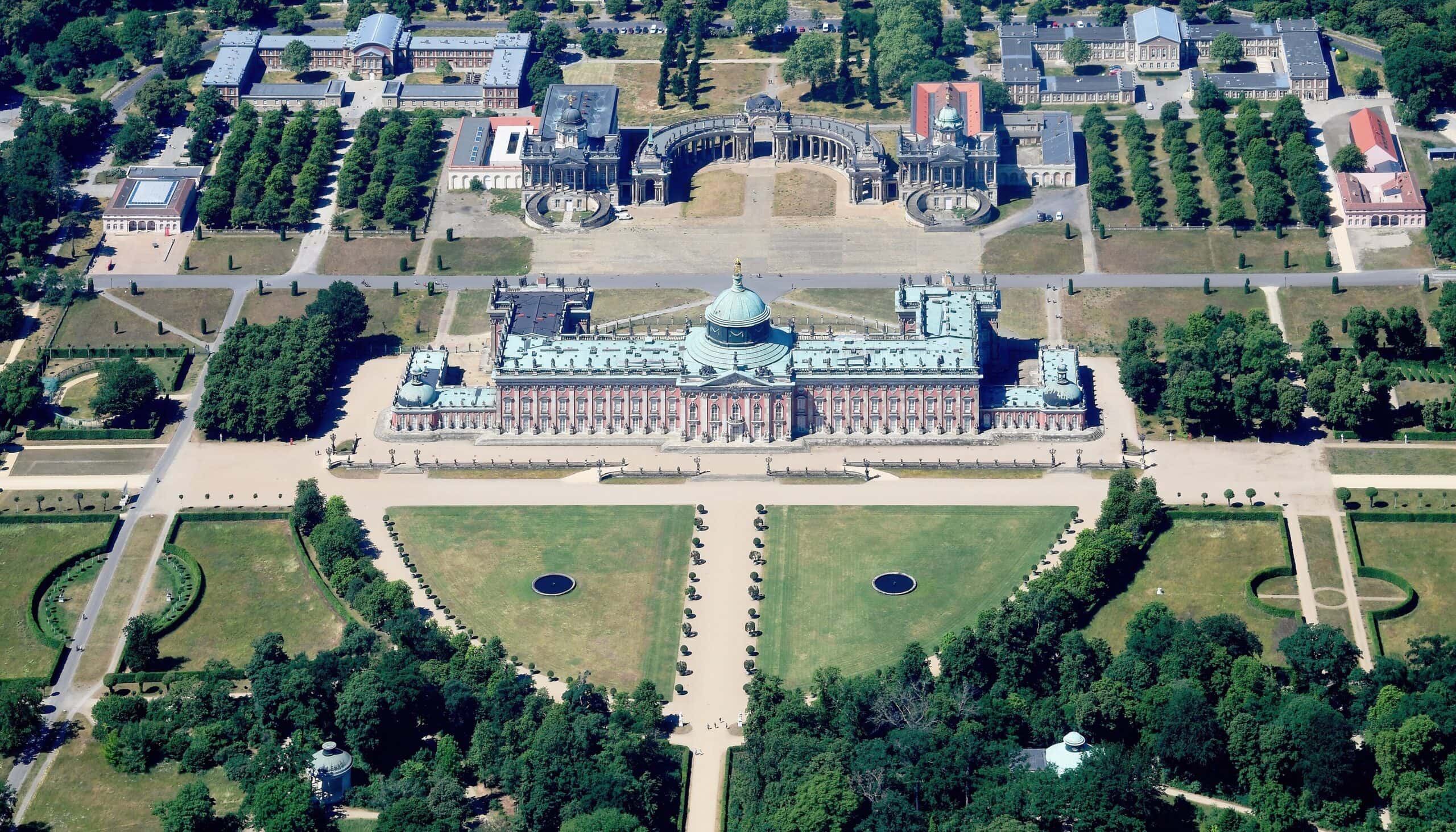 Aerial view of the Neues Palais from the east, closing the western end of Sanssouci Park with its Communs behind
