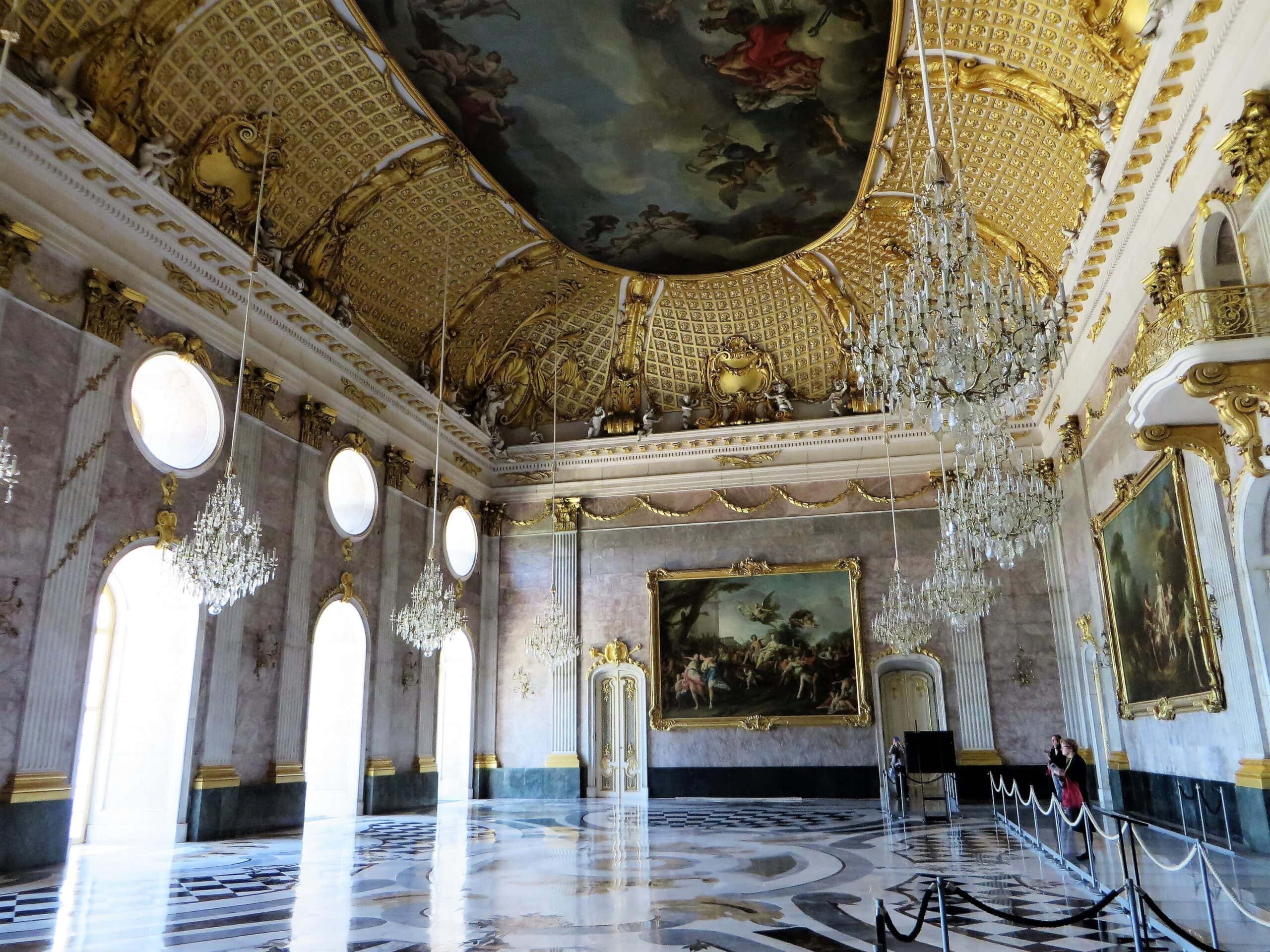 The Marble Hall of the Neues Palais, a two-storey festival hall with van Loo's painted Ganymede ceiling and crystal chandeliers
