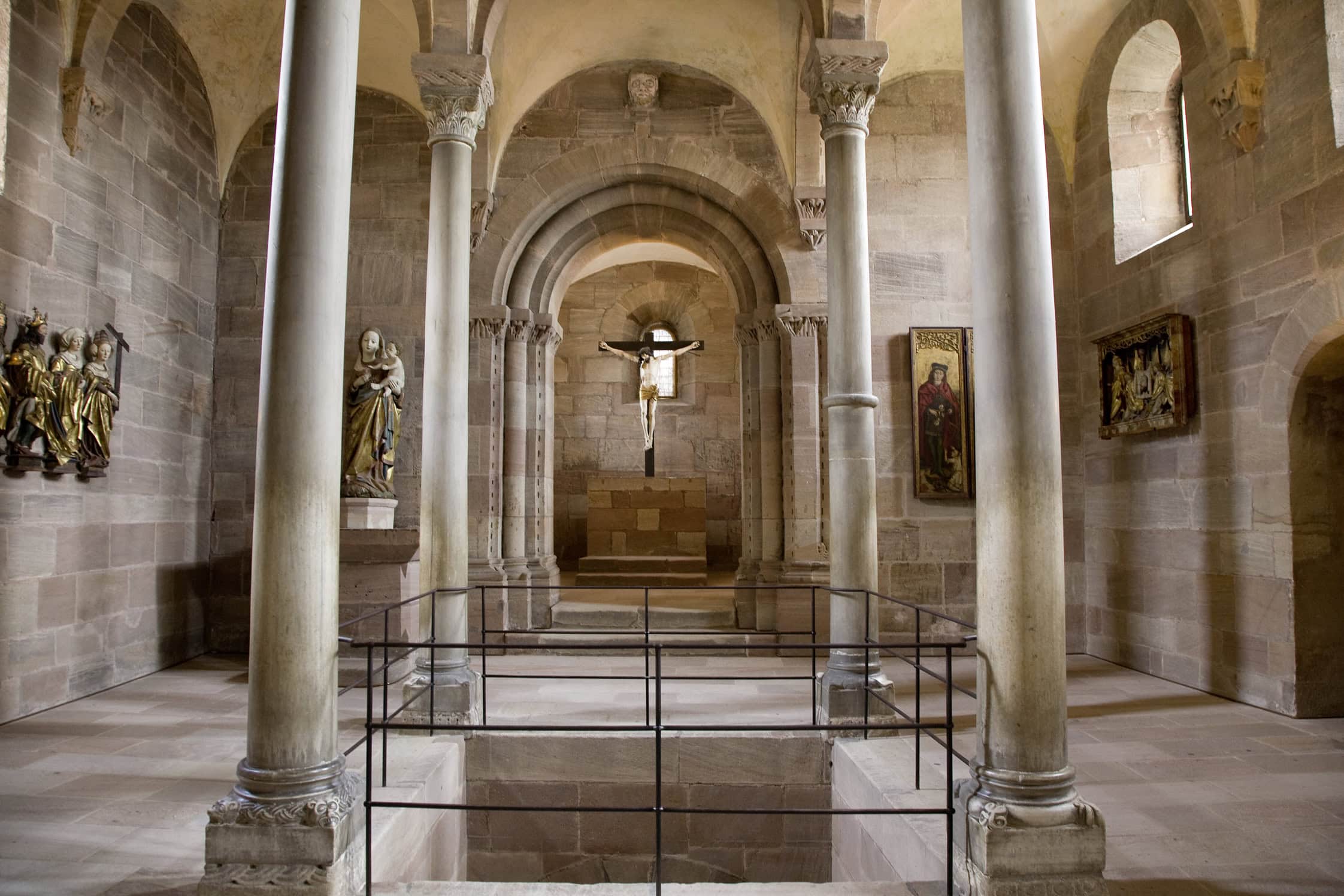 Nuremberg Castle 2 Interior of the upper Kaiserkapelle of the Doppelkapelle at Nuremberg Castle, raised by Heinrich VI between 1190 and 1197, showing four slender limestone columns rising to Romanesque foliage capitals around a square central opening cut through the floor to the lower chapel.
