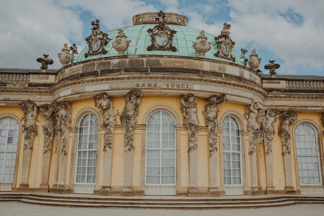 Sanssouci Palace 3 The bowed garden front of Sanssouci Palace with its dome, the gilded Sans Souci inscription and Glume's sandstone bacchants