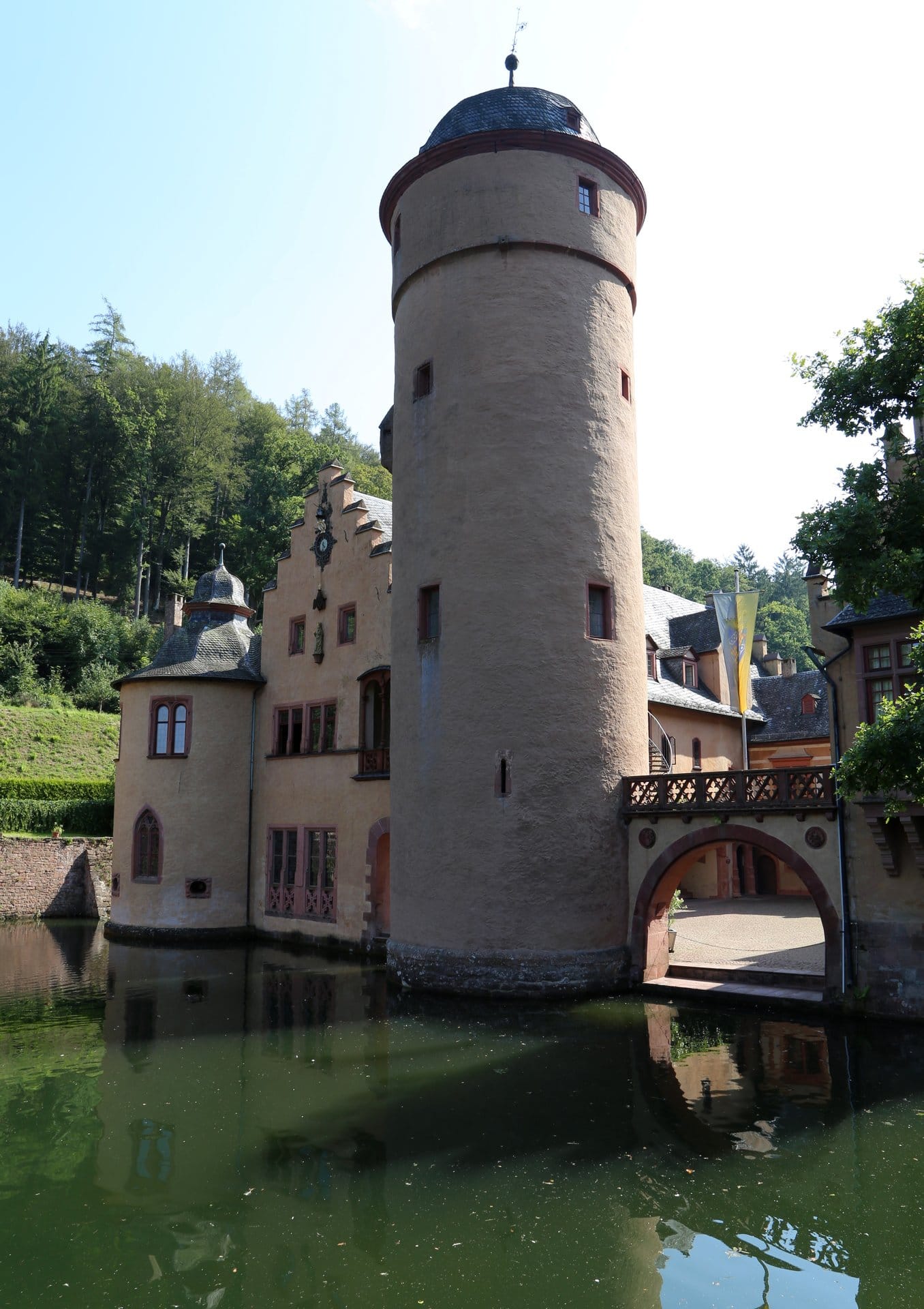 Mespelbrunn Castle 2 The round Bergfried of Schloss Mespelbrunn rising directly from the water of the moat, showing the lower courses raised by Hamann II Echter between 1427 and 1434 and the upper stage added by Adolf Echter from 1581.