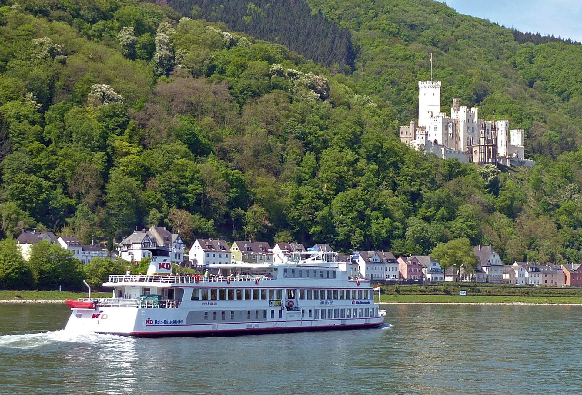 The 19th-Century Romantic Revival of German Castles 3 Stolzenfels Castle viewed from the Rhine, a yellow Schinkel silhouette above the river with a passing steamer in the foreground.
