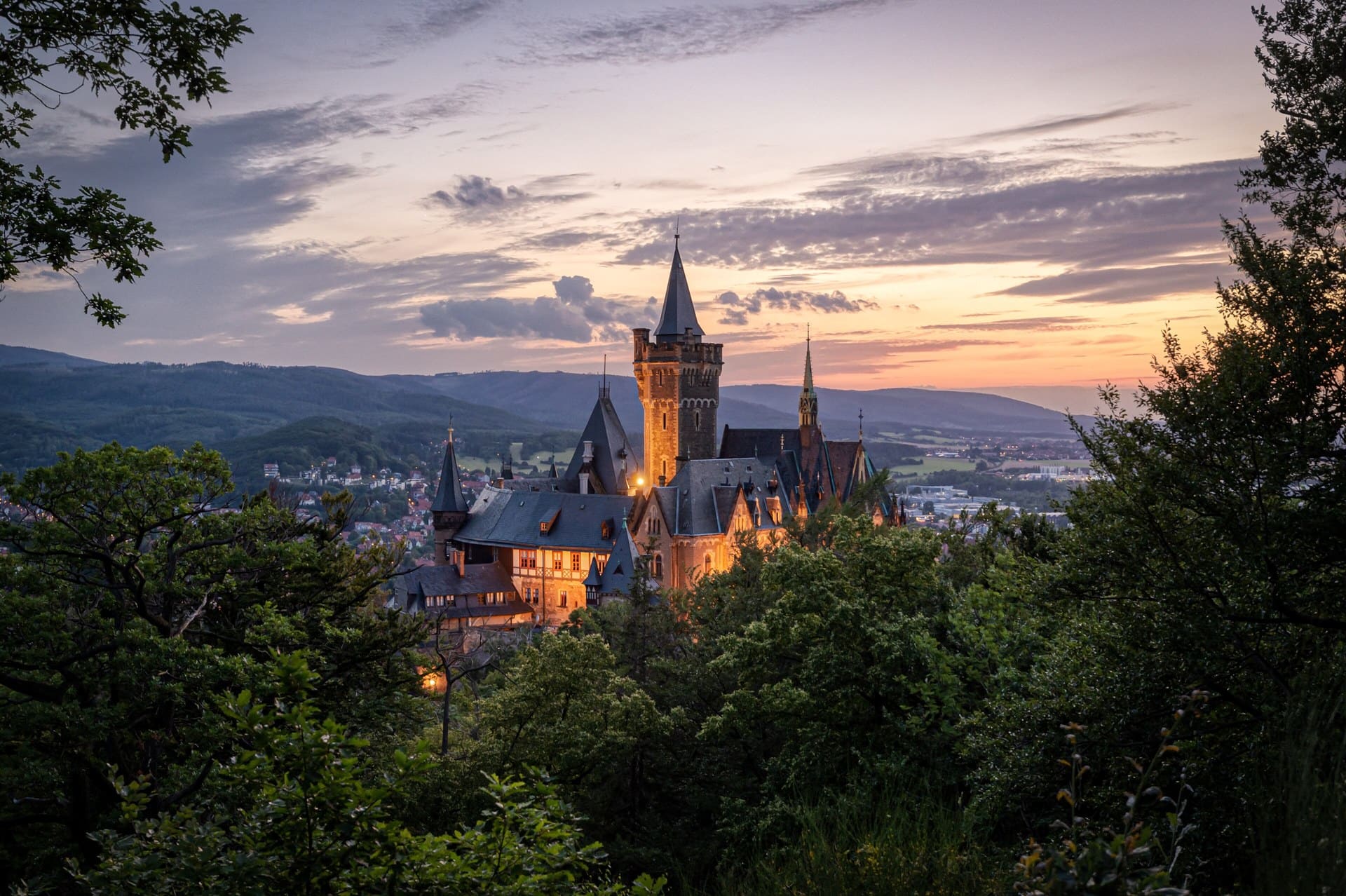 The 19th-Century Romantic Revival of German Castles 10 Wernigerode Castle at sunset, silhouetted on the Agnesberg ridge above the town.