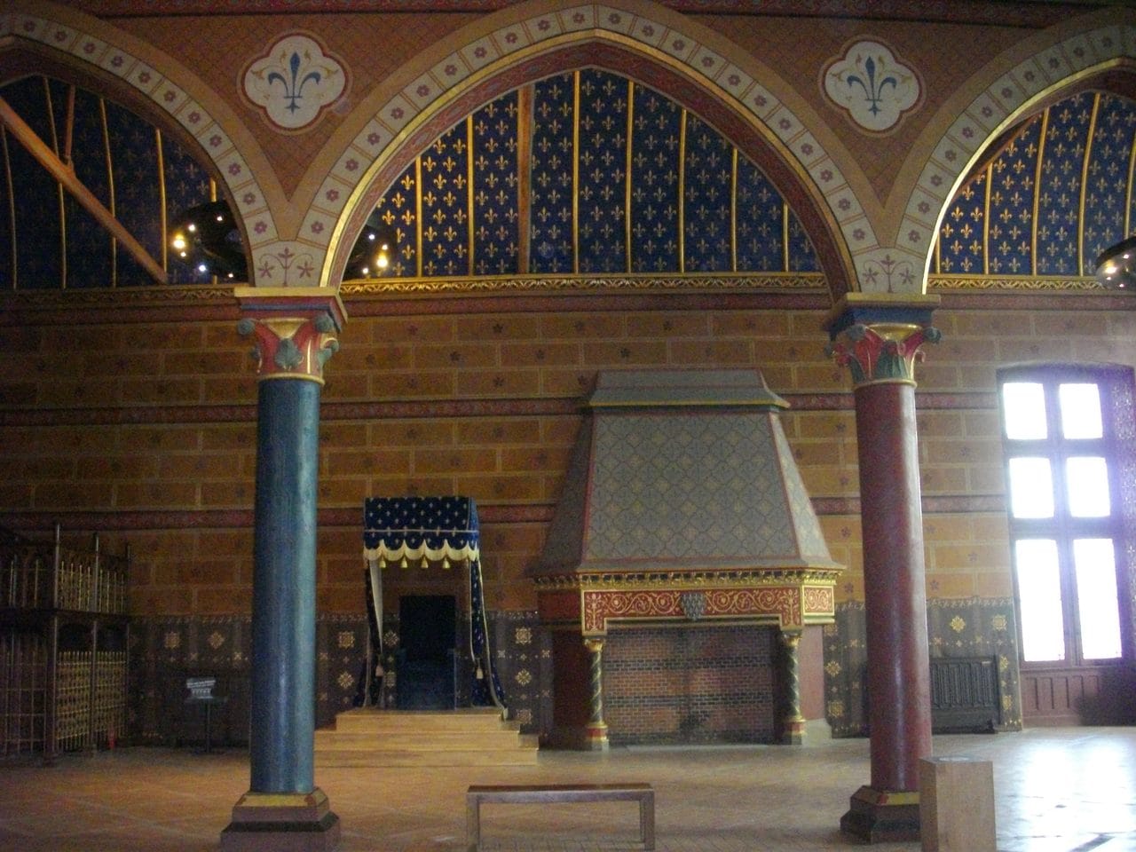 Fab5669, CC BY-SA 4.0, via Wikimedia Commons Throne canopy and monumental fireplace in the Salle des États