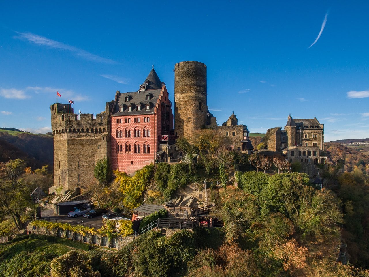 Castle Hotels in Germany: Where You Can Actually Sleep Inside the History 2 Burghotel auf Schonburg above Oberwesel, the towers and red Gothic Revival palas of the castle hotel