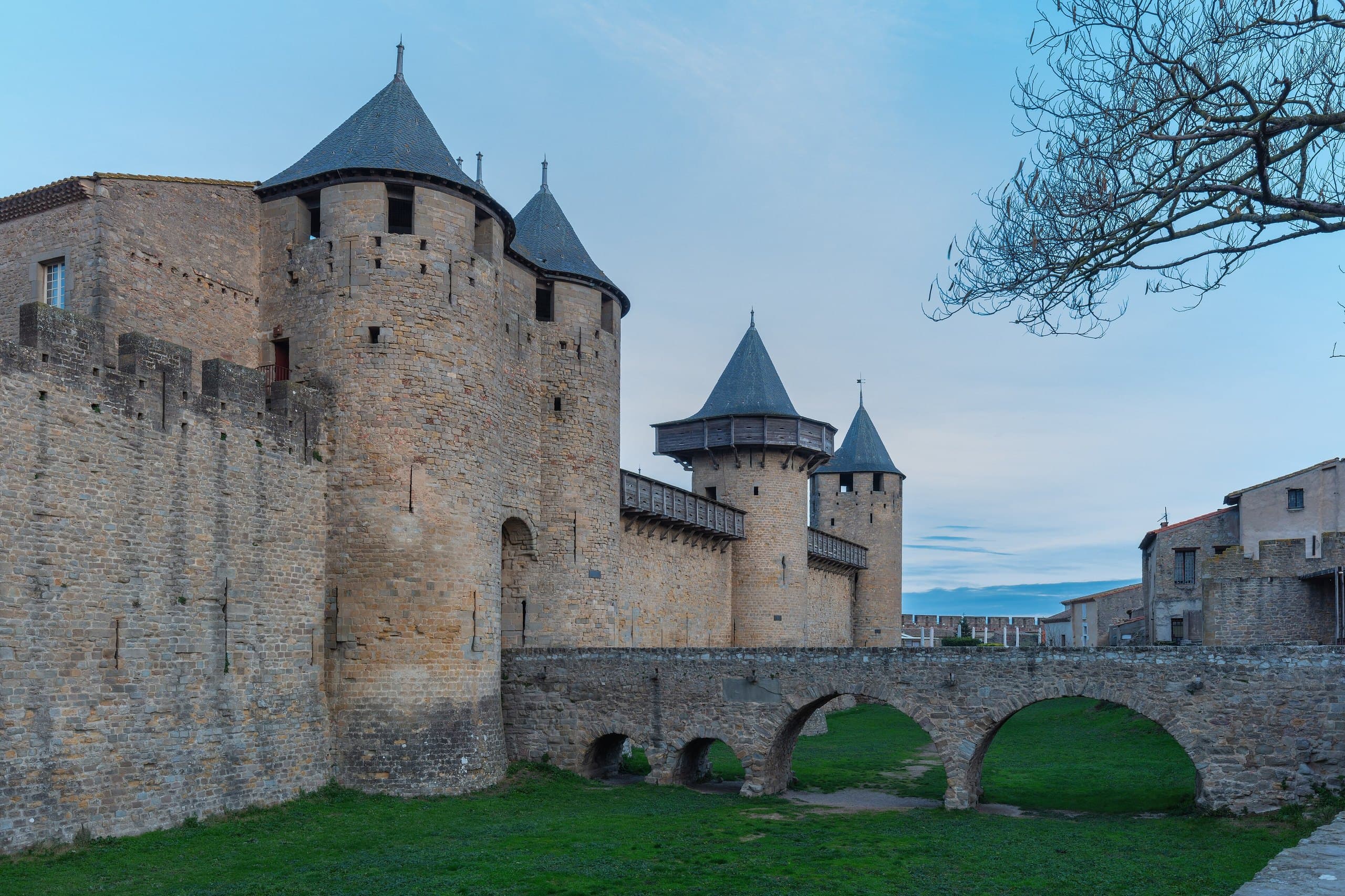 Carcassonne Castle 1 The Château Comtal of Carcassonne and its stone bridge over the dry moat at dusk