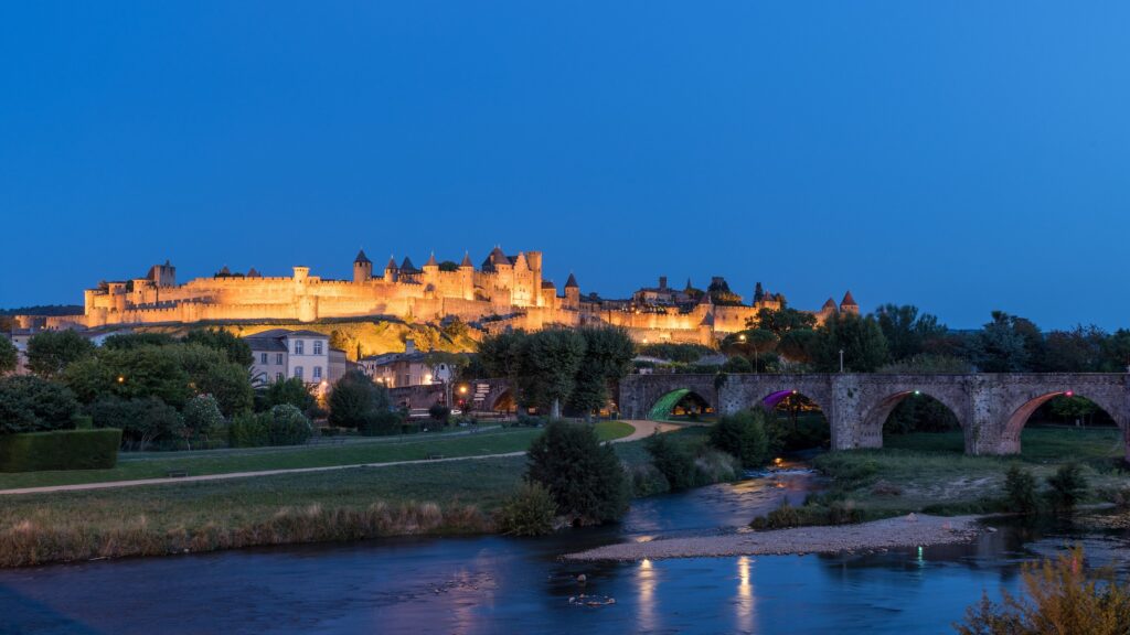 The illuminated Cité de Carcassonne seen from the Pont Neuf at blue hour