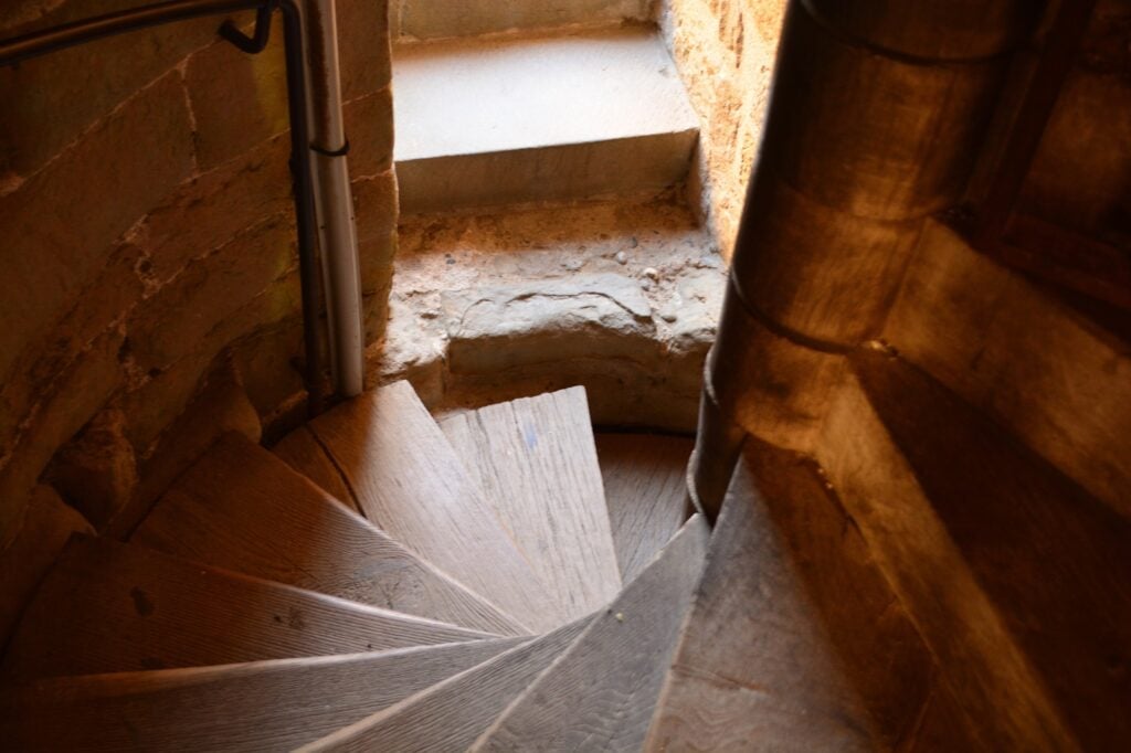 A worn spiral stair inside a tower of the Château Comtal