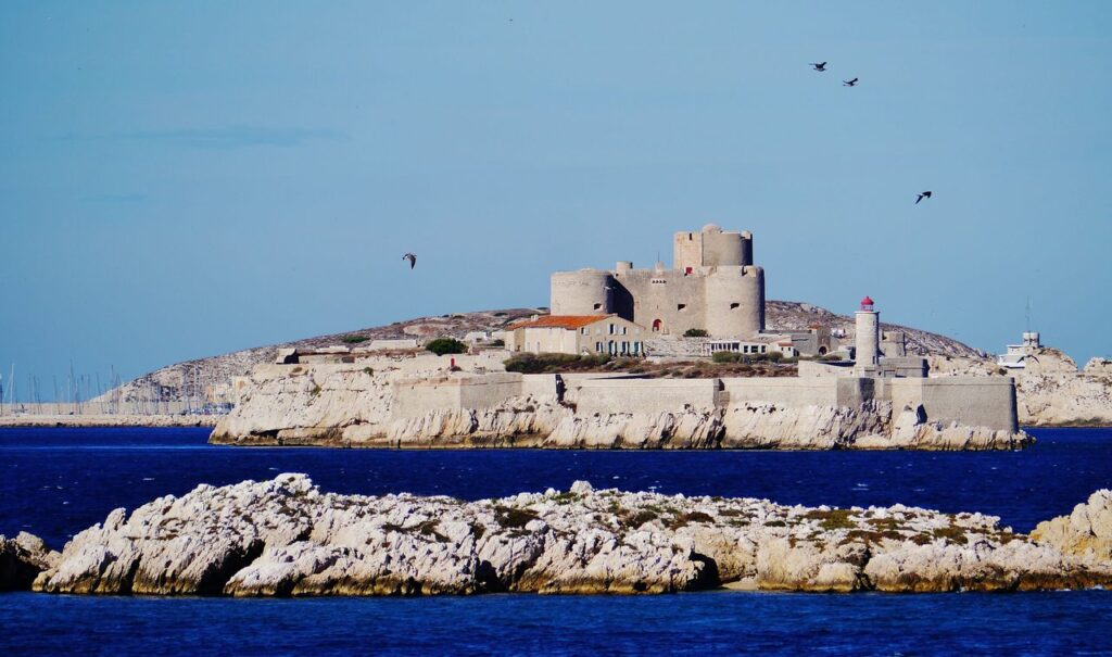 Château d'If seen across turquoise water from the Marseille corniche.