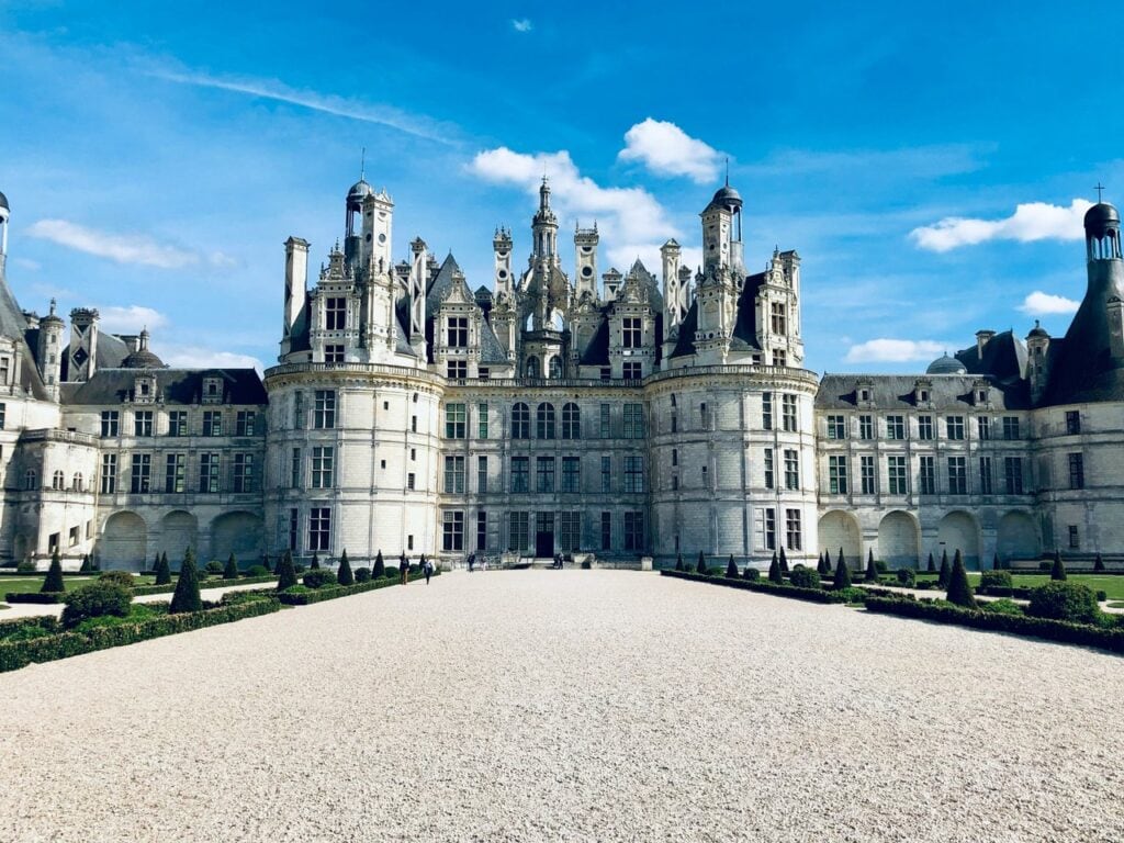 Château de Chambord 13 The symmetrical front facade of Chateau de Chambord under a blue sky