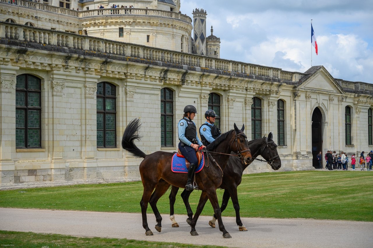 Château de Chambord 9 Mounted Garde republicaine riding past the facade of Chateau de Chambord