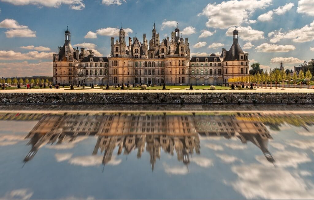 Château de Chambord 14 Chateau de Chambord reflected in water with a dramatic sky