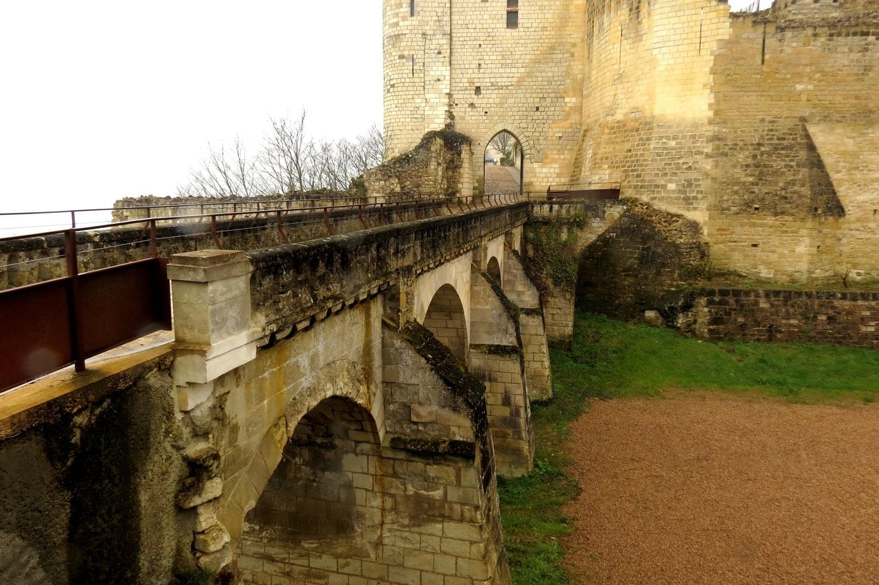 Château de Chinon 8 Stone bridge crossing the dry ditch toward a pointed-arch gate tower
