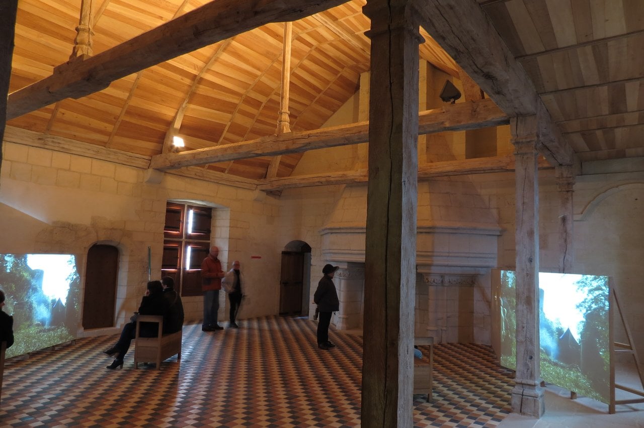 Château de Chinon 14 A restored hall with timber roof, stone fireplace and tiled floor