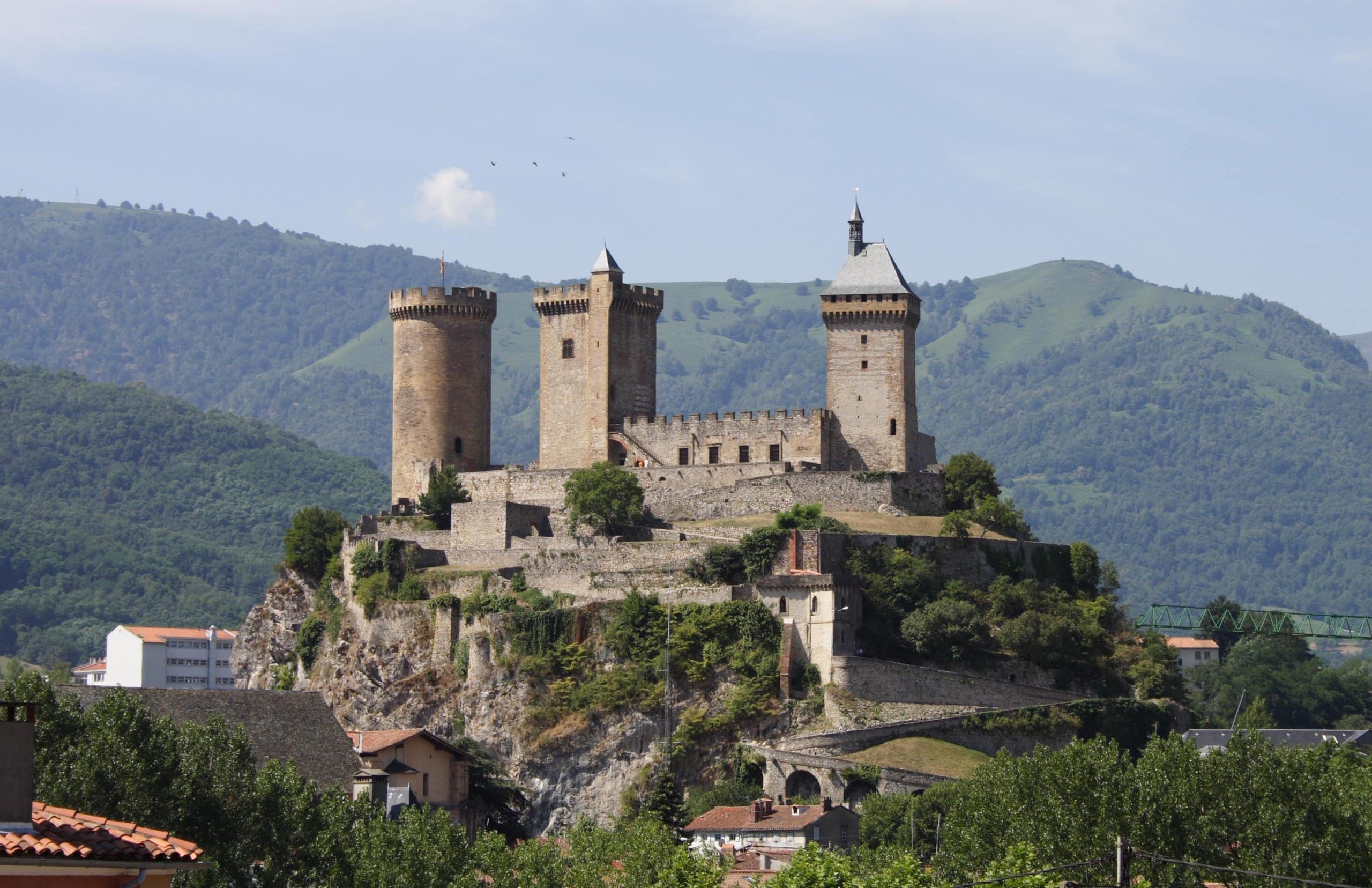 Château de Foix 1 Château de Foix, its three medieval towers rising above the town and the Pyrenees
