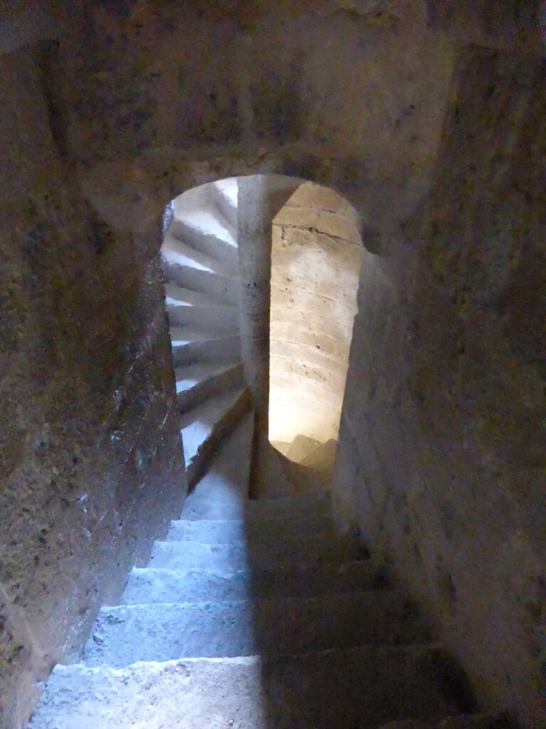 Spiral stone staircase inside a turret at Château de Quéribus
