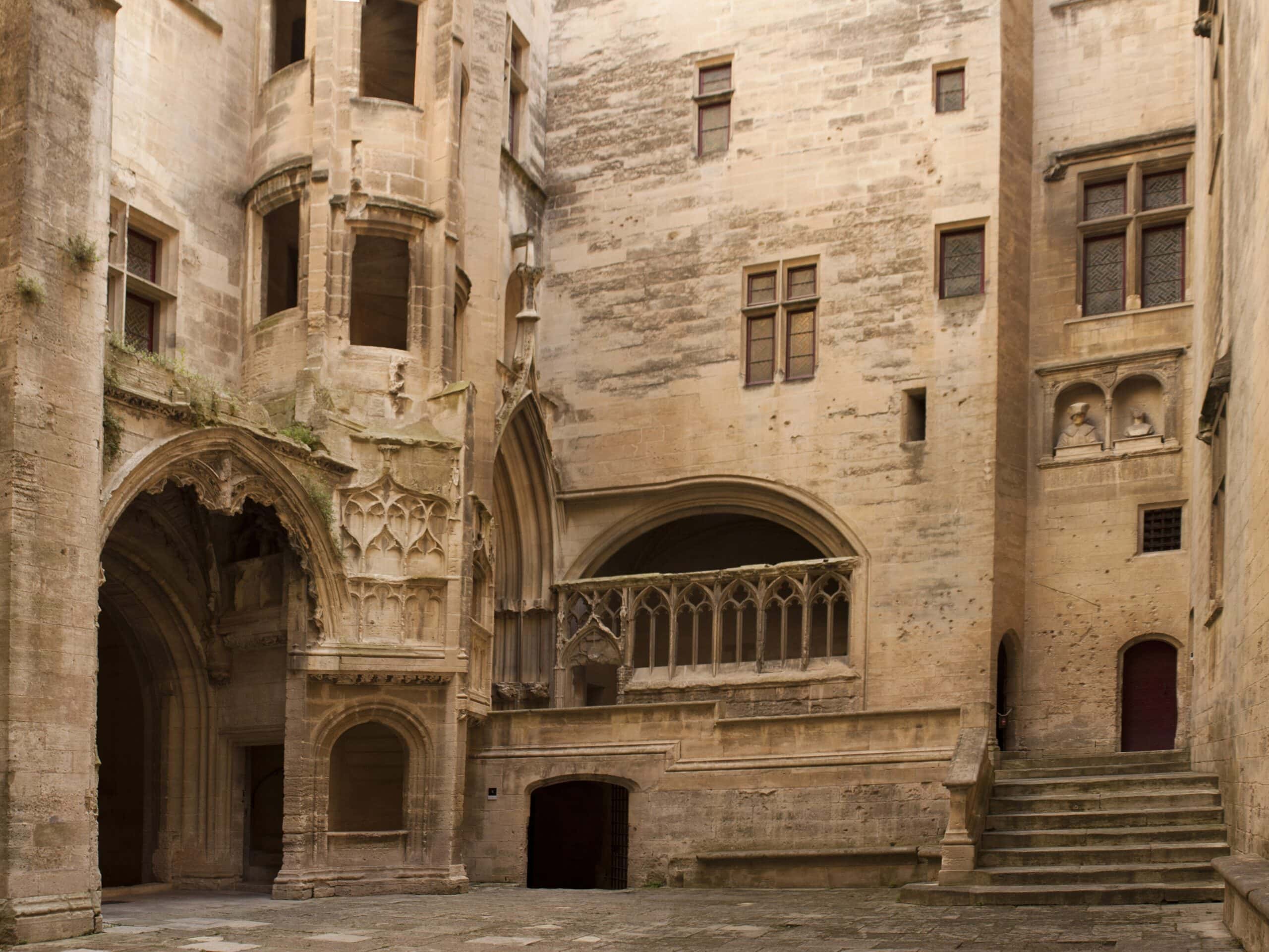 Château de Tarascon 3 The Gothic courtyard of Château de Tarascon with carved arches and a flamboyant staircase