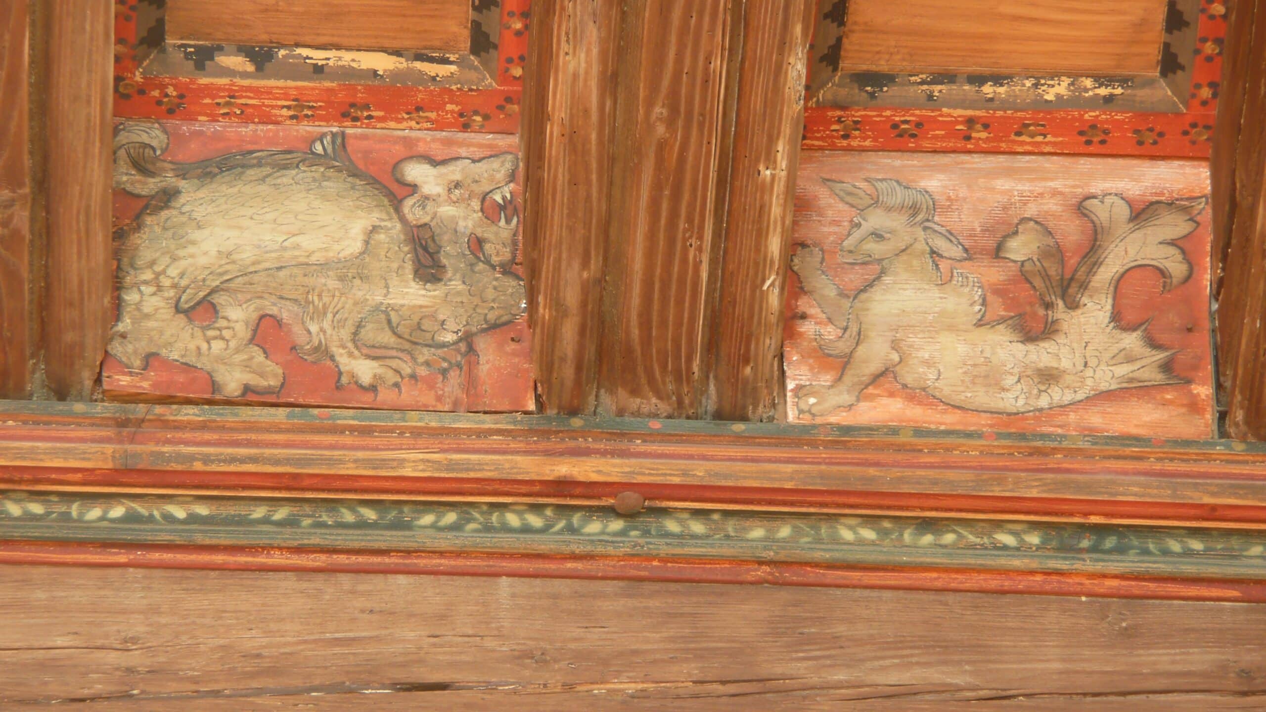 Château de Tarascon 5 Painted bestiary creatures, a winged dragon and a horned beast, on a timber ceiling at Château de Tarascon