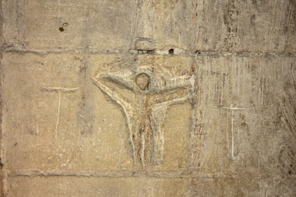 Château de Tarascon 10 A prisoner's carving of crosses and a kneeling figure in a cell at Château de Tarascon