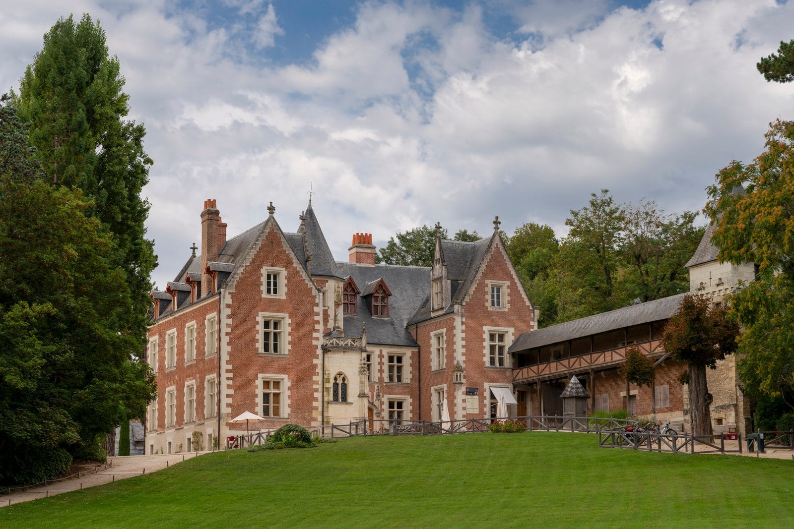 Château du Clos Lucé 1 Brick and tuffeau facades of Château du Clos Lucé in Amboise under a summer sky