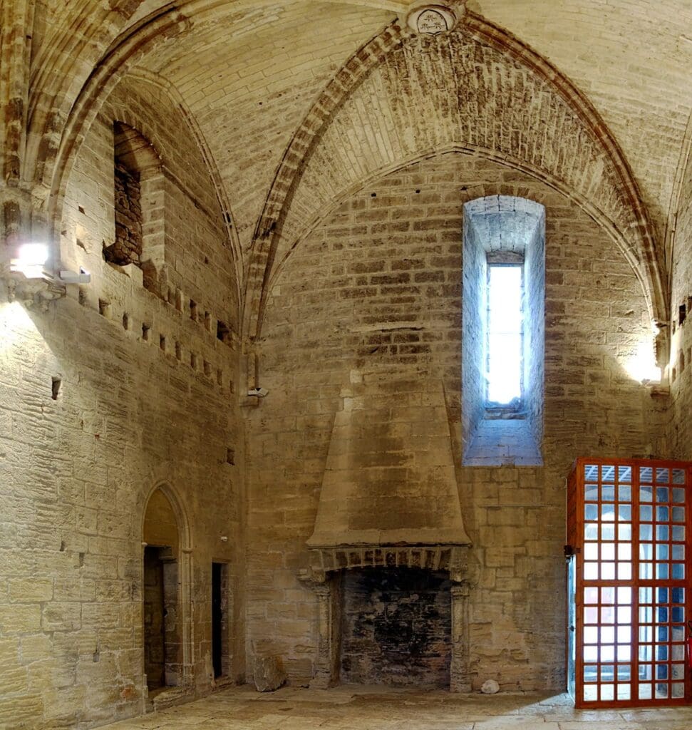 A vaulted hall with hooded fireplace inside the twin towers of Fort Saint-André.