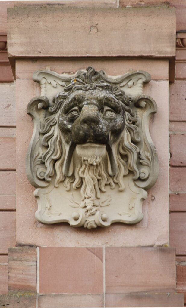 Carved stone lion's-head fountain spout on the Friedrichsbau at Heidelberg Castle