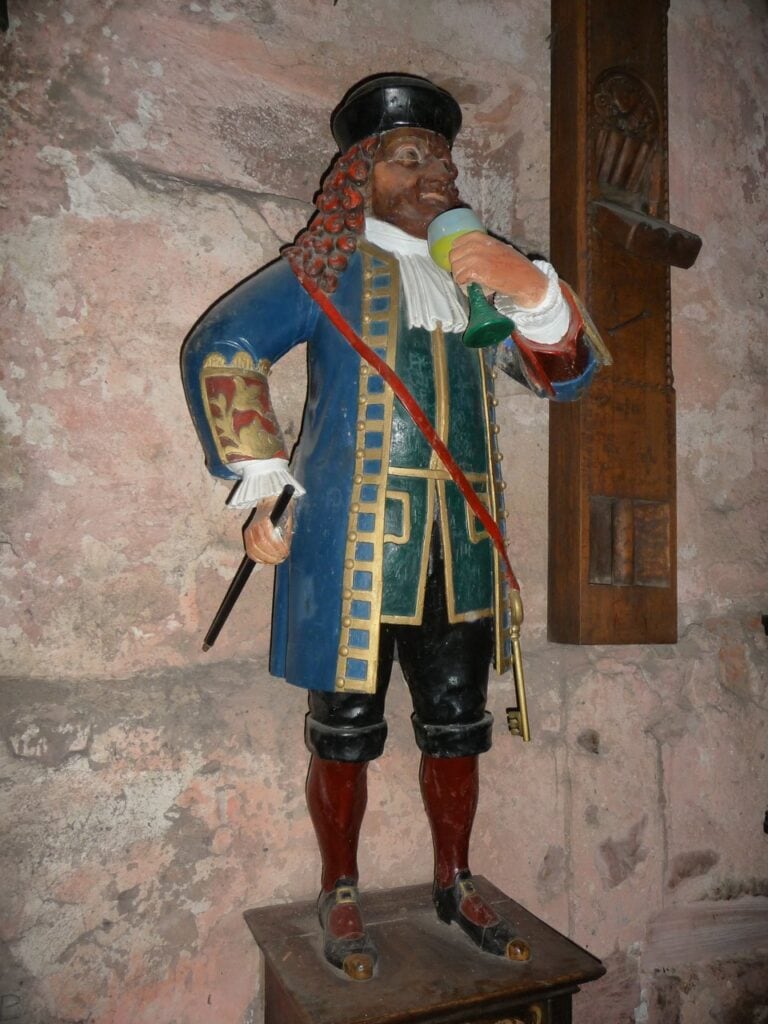 Carved figure of Perkeo, the court jester, who stands beside the Great Barrel at Heidelberg Castle