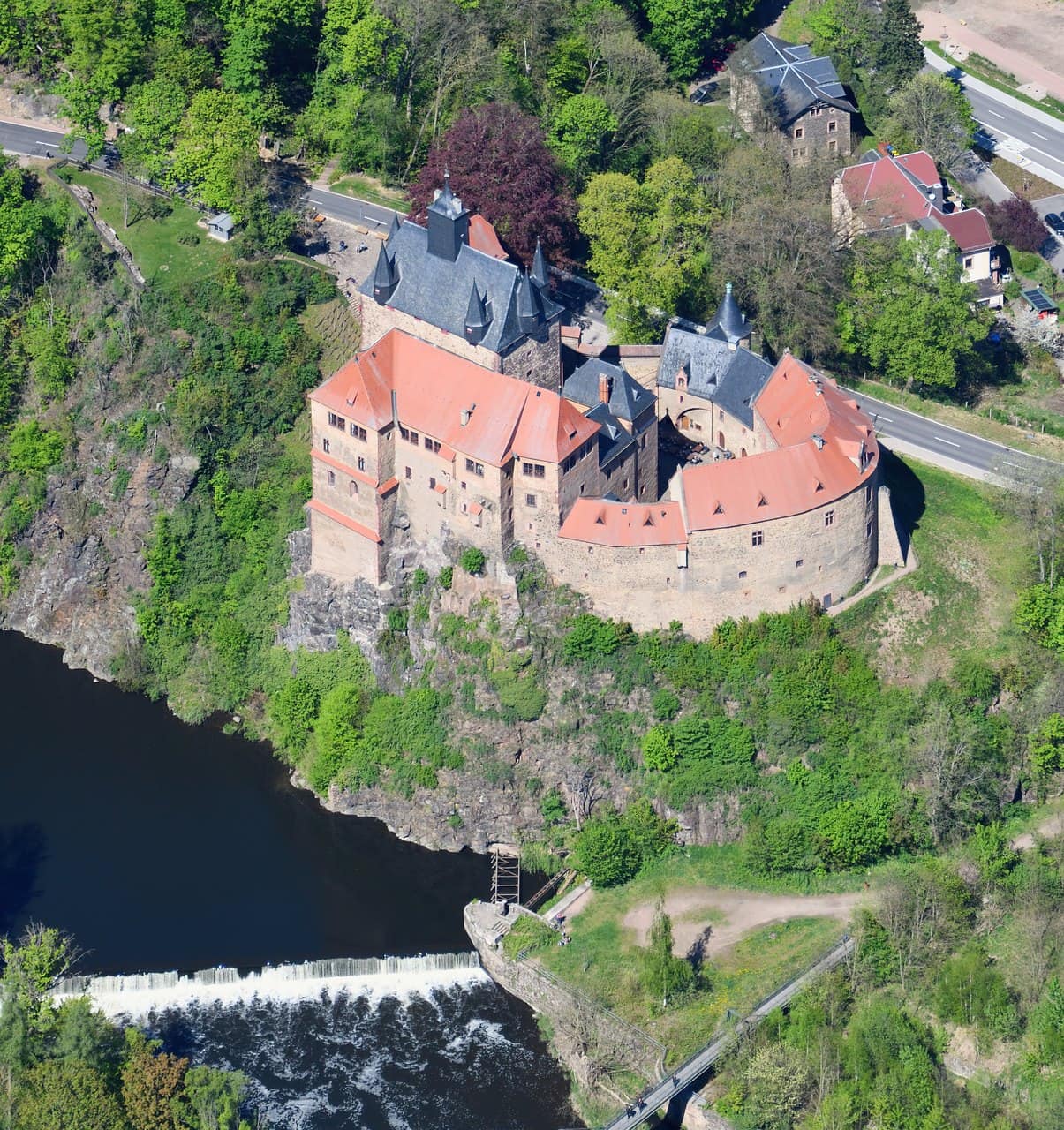 Aerial view of Kriebstein Castle from the south showing its compact oval plan above the Zschopau