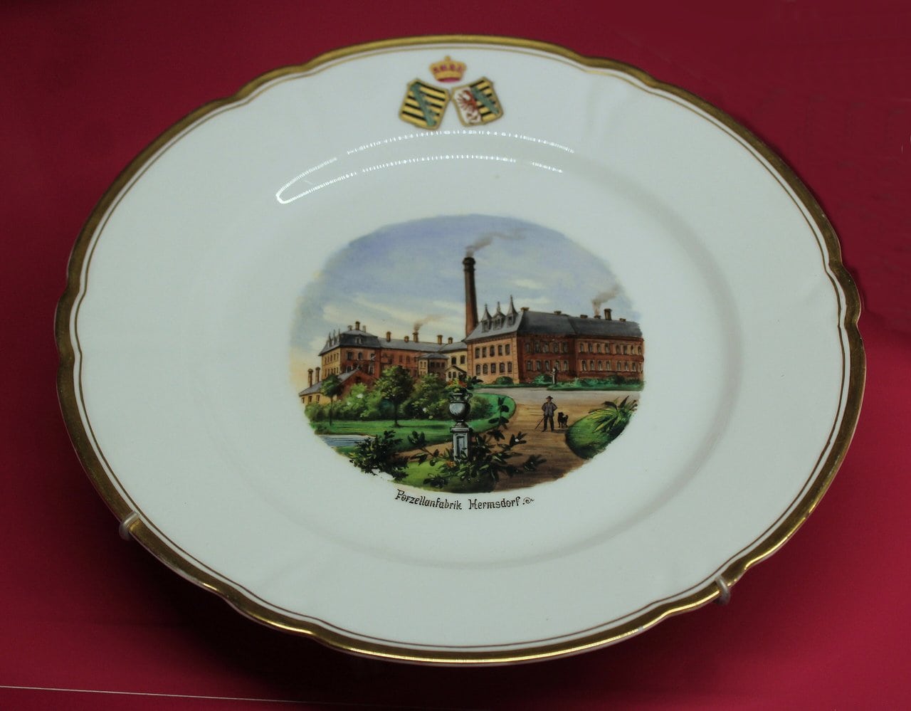 Leuchtenburg Castle 6 Hand-painted porcelain plate in the Leuchtenburg museum showing the Hermsdorf porcelain factory beneath a ducal coat of arms