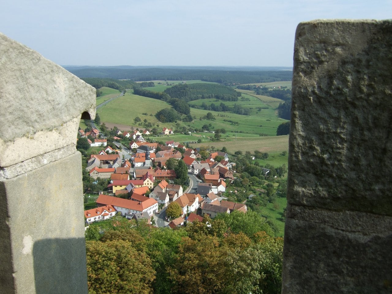 View from the keep — Sebastian Wallroth, public domain, via Wikimedia Commons View from the keep of Leuchtenburg Castle down over the village of Seitenroda and the surrounding hills