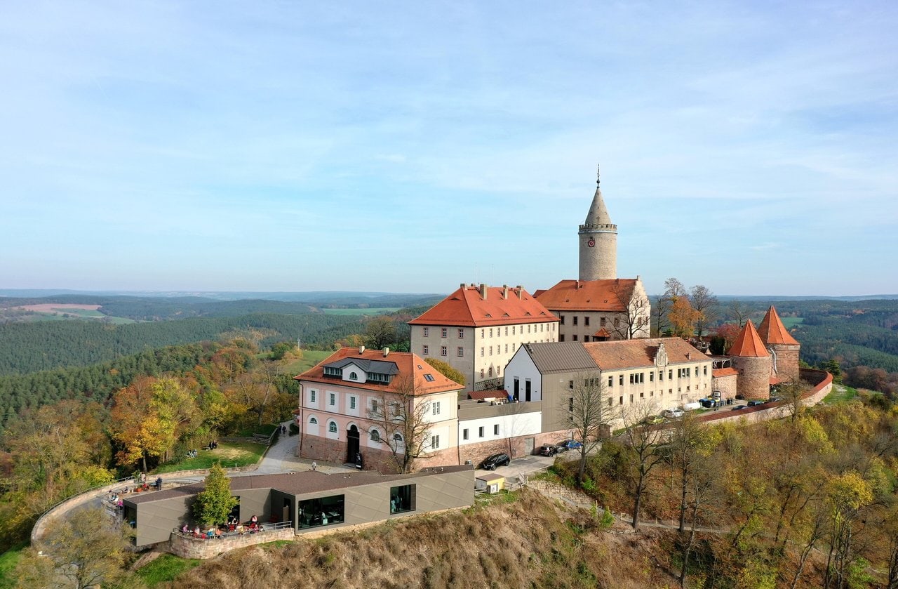 Leuchtenburg Castle 1 Aerial view of Leuchtenburg Castle on its wooded hilltop above the Saale valley in autumn