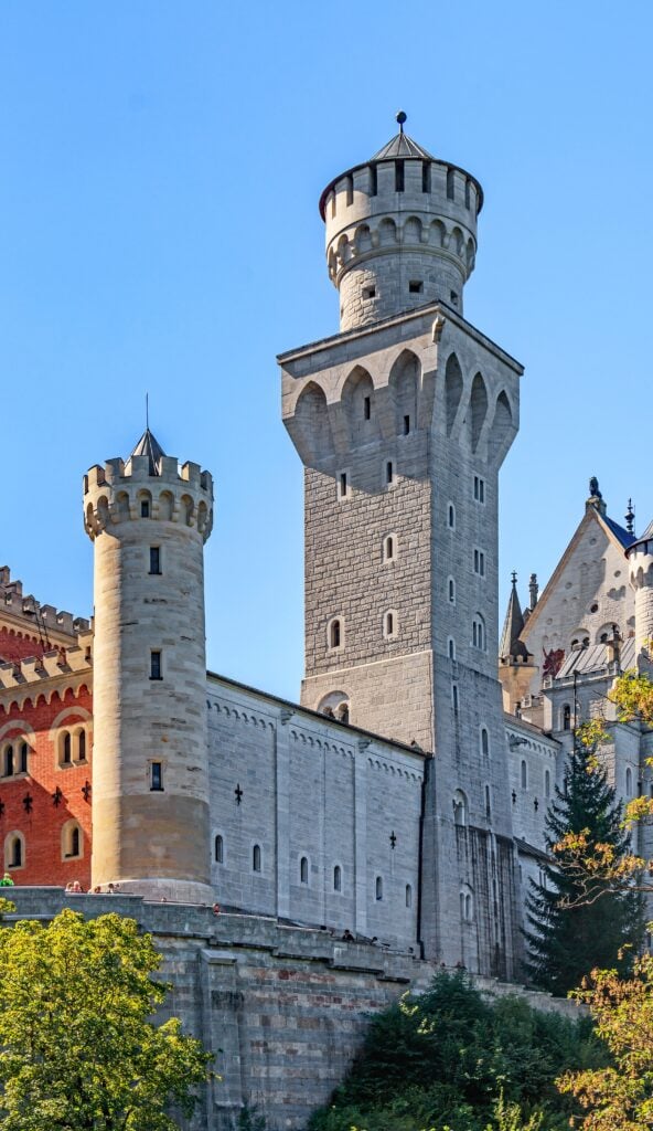 Neuschwanstein Castle 14 The tall square tower and white turreted walls of Neuschwanstein Castle rising against a blue sky