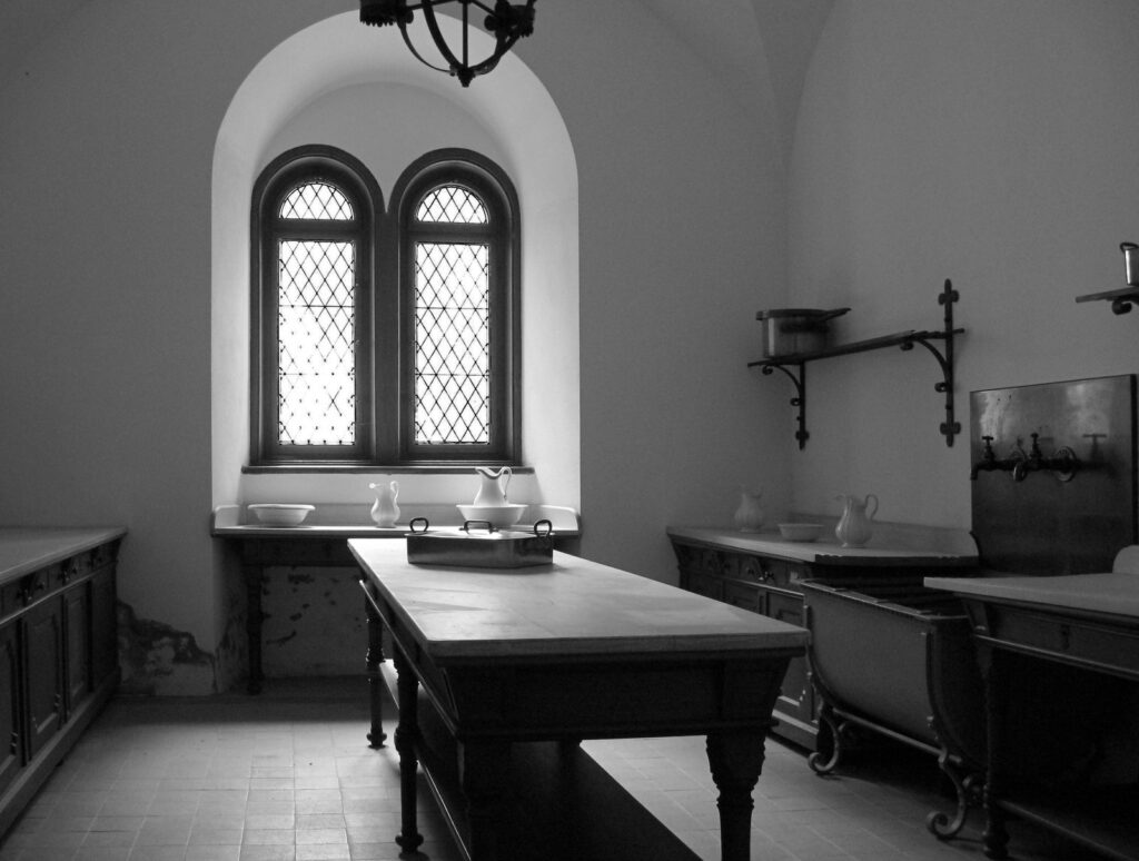Neuschwanstein Castle 22 The vaulted kitchen of Neuschwanstein Castle with a central work table, arched windows, and period fittings