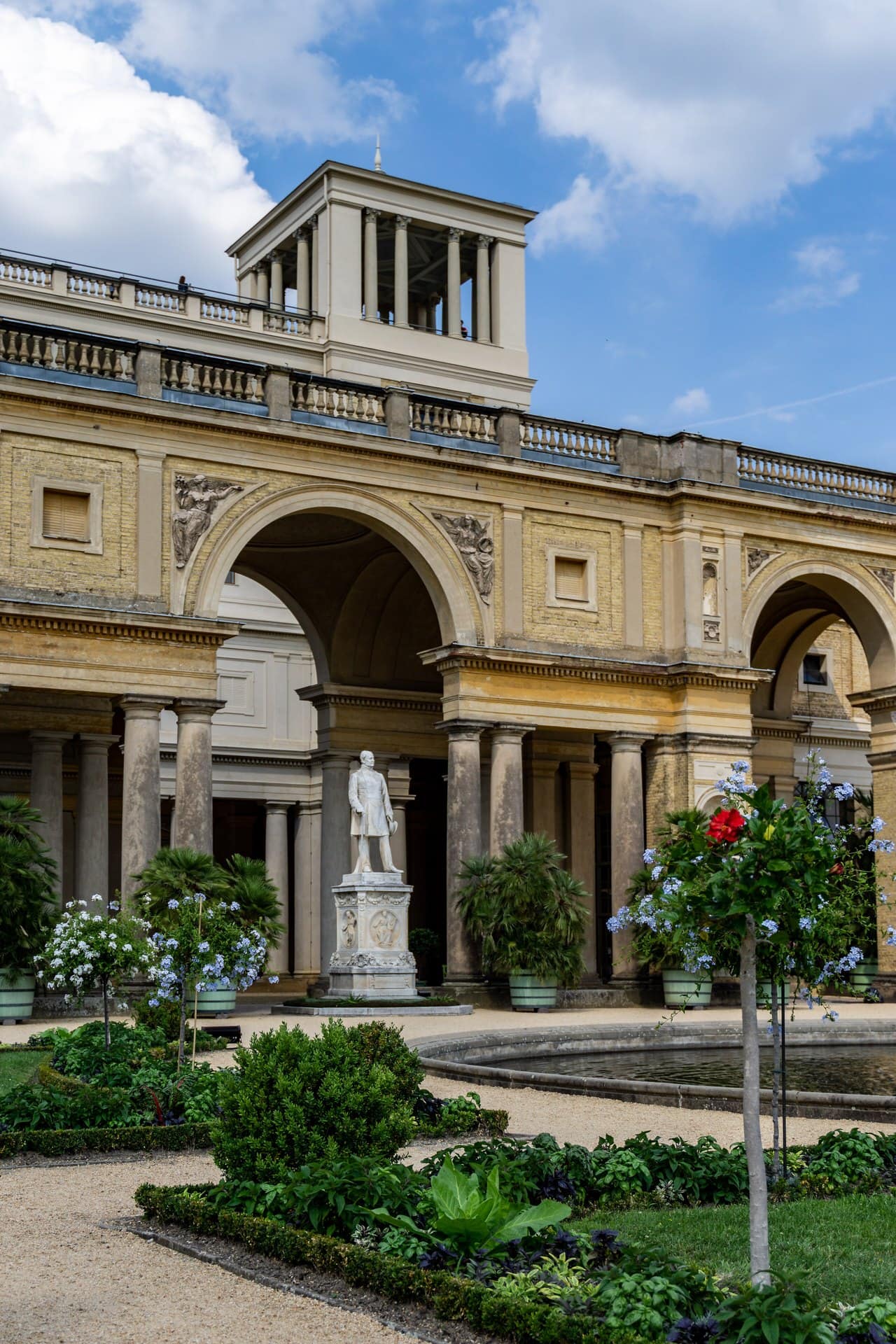 Orangery Palace 4 An arcaded block of the Orangery Palace above a terraced parterre with a marble statue, in Sanssouci Park