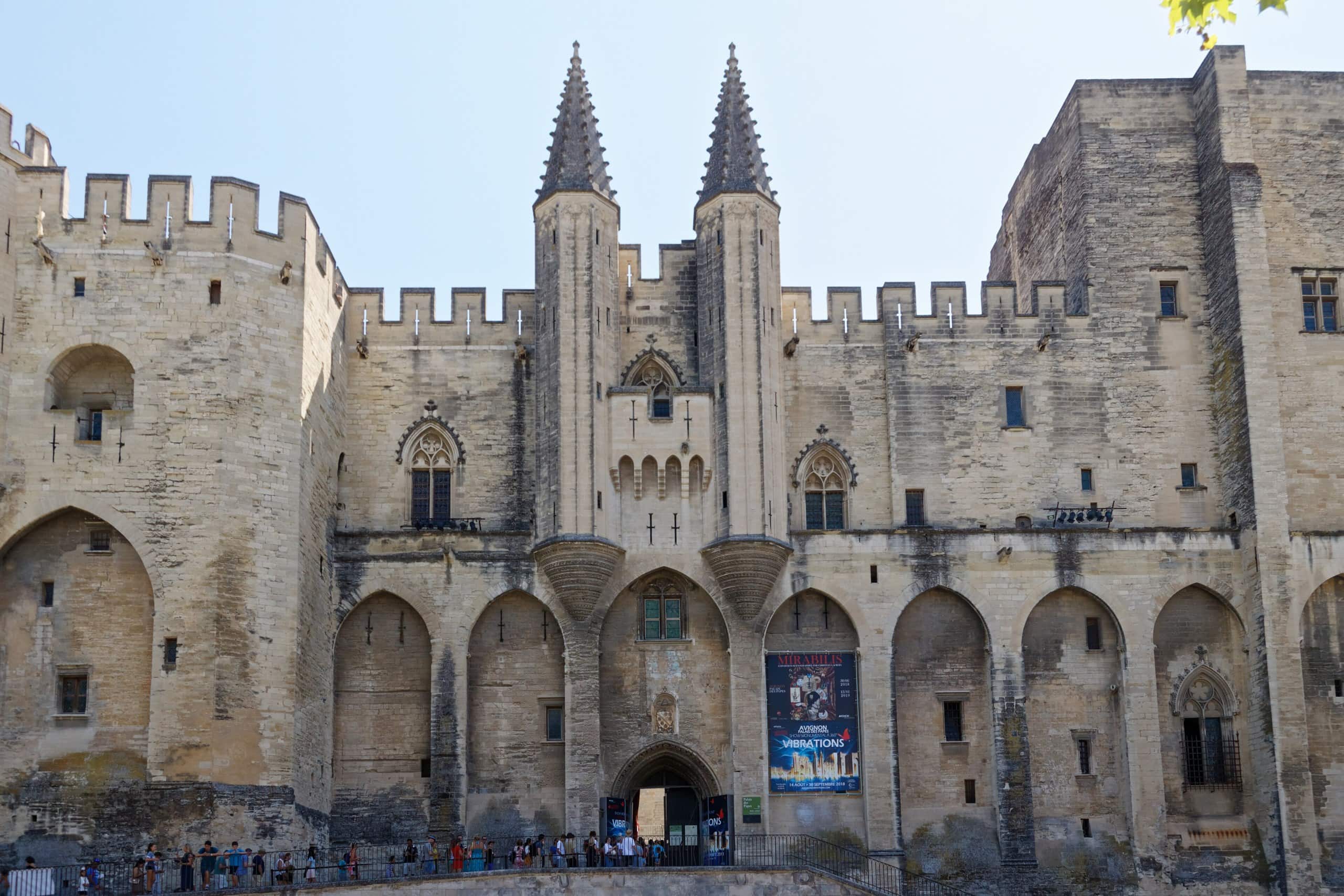 Castles of Provence: Four Great Strongholds of the South 4 Wide view of the fortified facade of the Palais des Papes across the Place du Palais