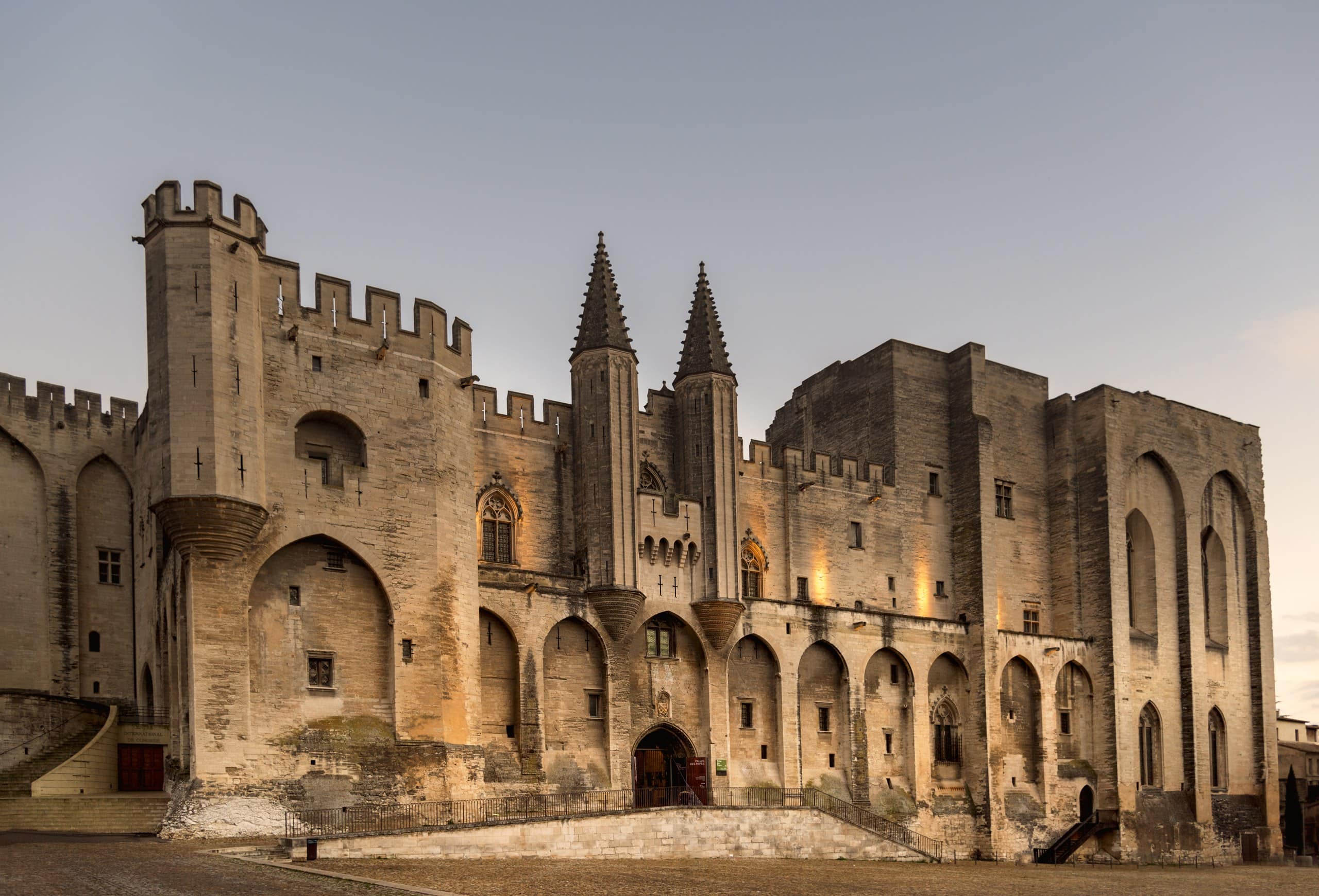 The west facade of the Palais des Papes in Avignon, with the twin turrets of the Champeaux gate