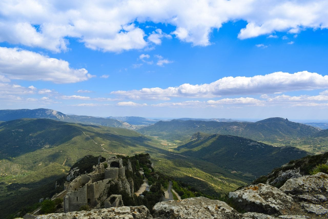 View south toward the frontier — Fred Passat / Unsplash View south from Peyrepertuse over the Corbières toward the old Aragonese frontier