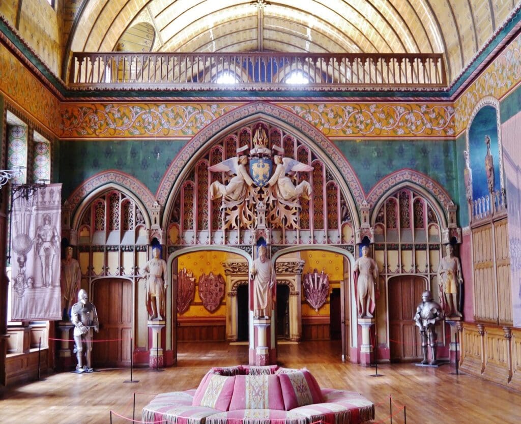 Château de Pierrefonds 10 Detail of the Salle des Preuses, the imperial eagle arms held aloft by carved angels above the arcades